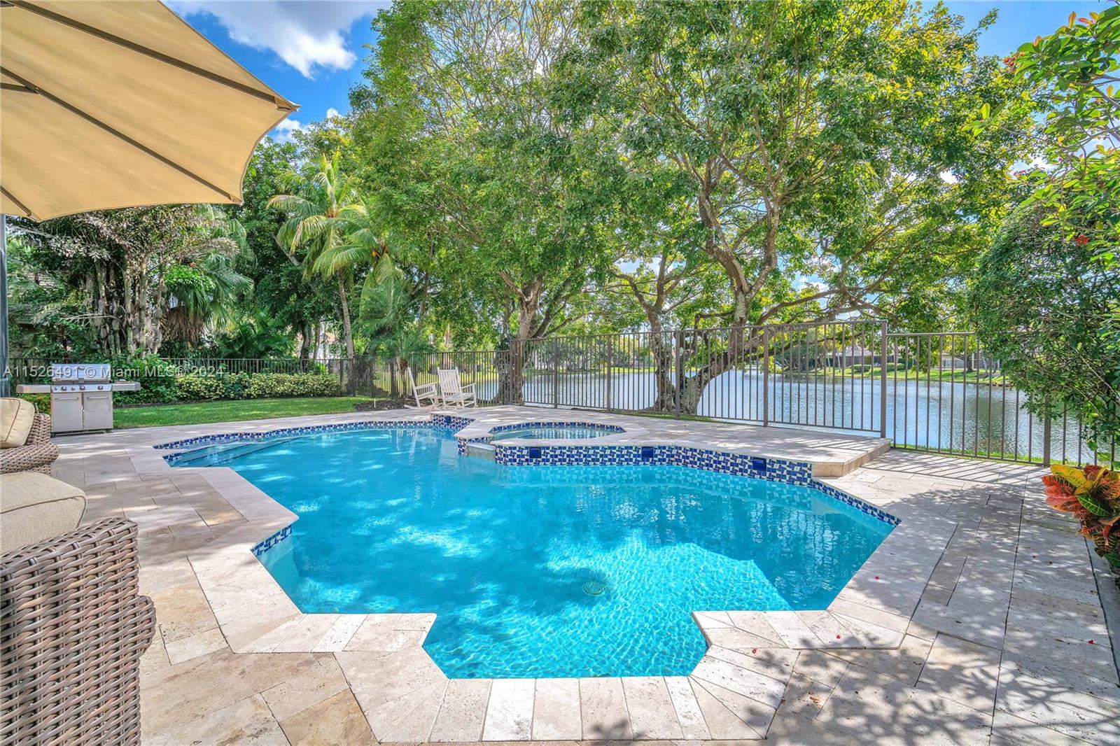 Resort-style backyard, fully fenced yard, travertine deck.