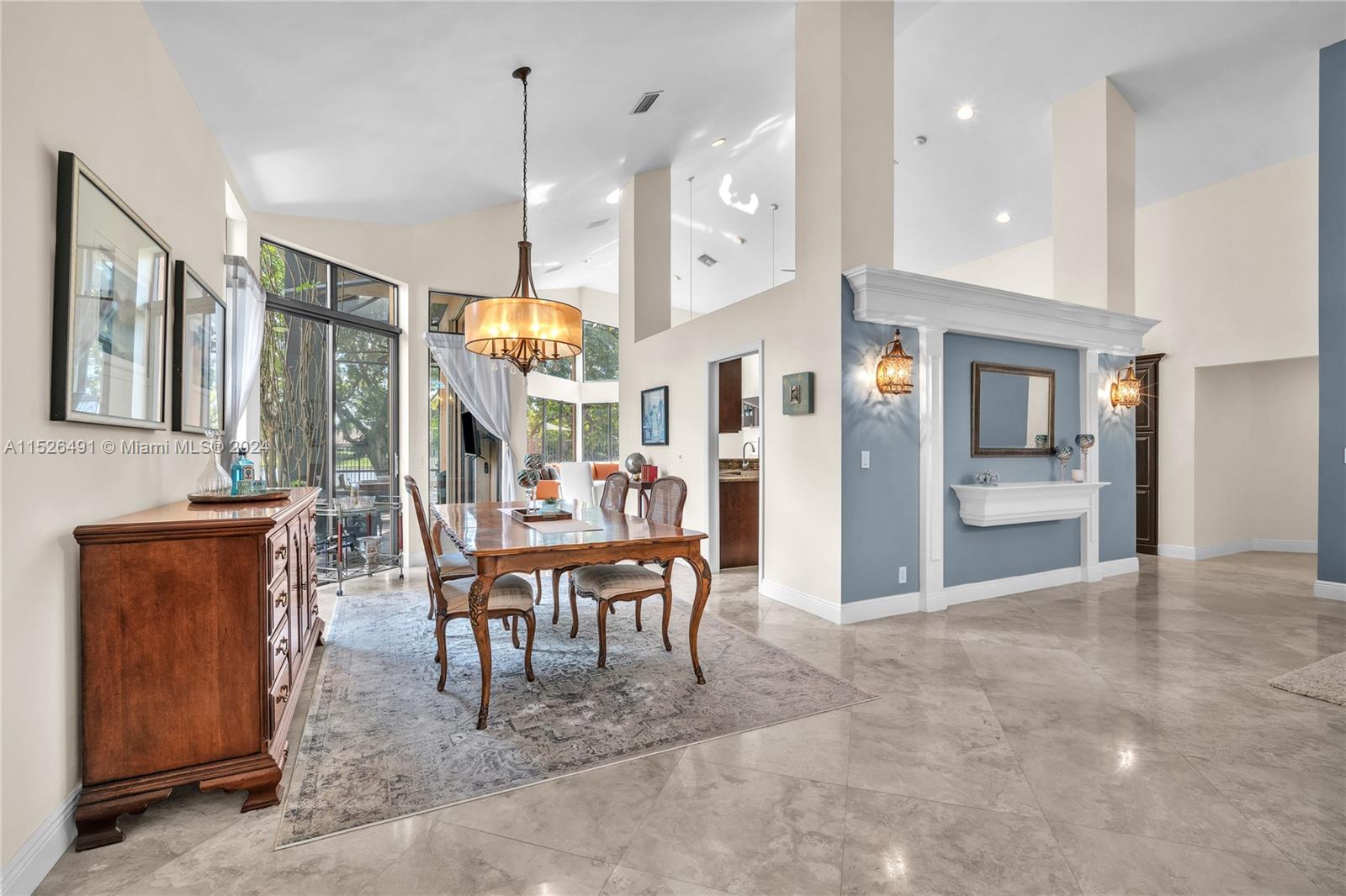 Dining room leads to outdoor sunroom.