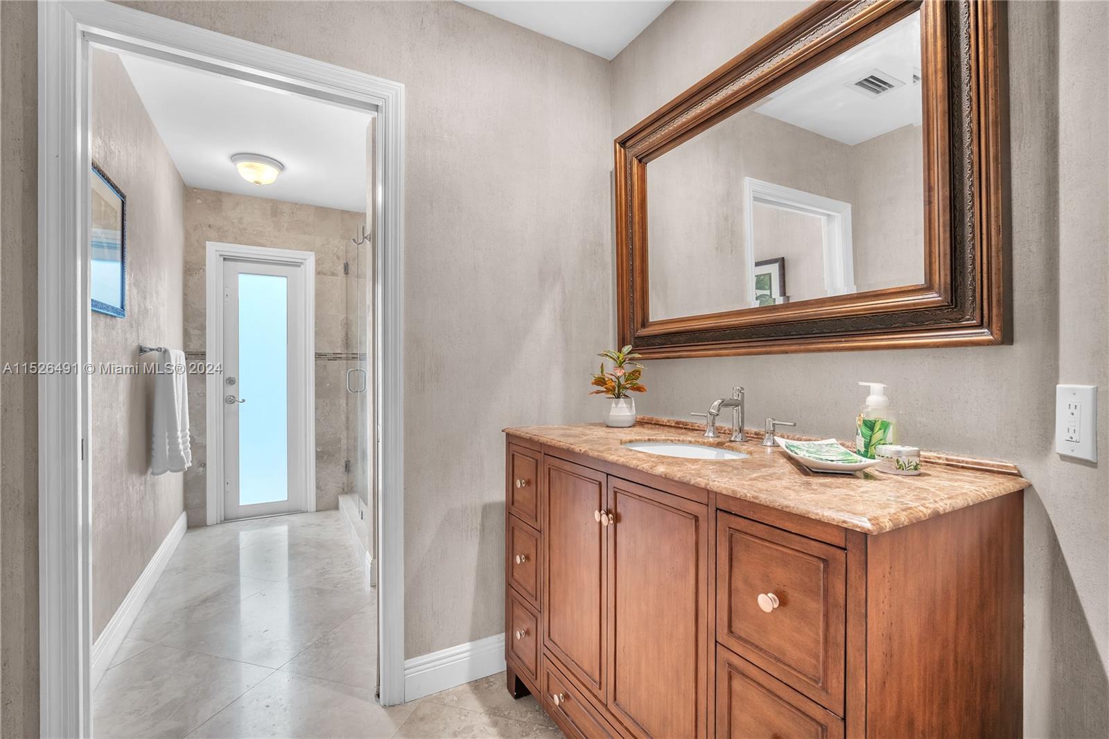 Renovated cabana bathroom with new impact door.