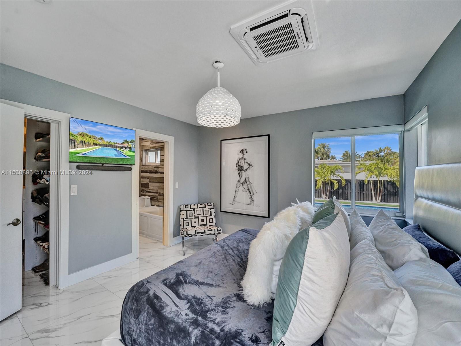 Primary bedroom with walk in closet and en-suite bath