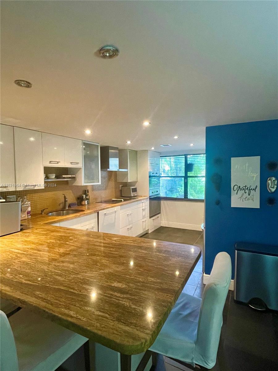 Open kitchen with a large granite bar