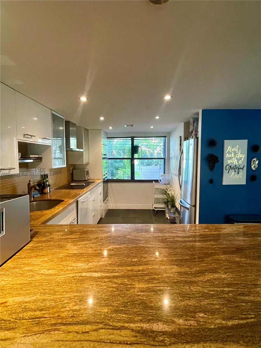 Renovated open kitchen with a large granite bar.