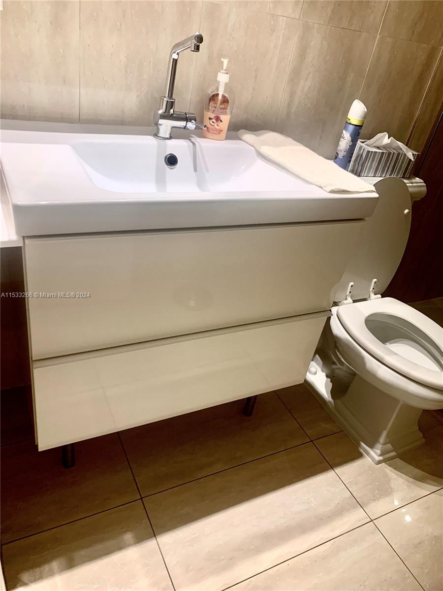 FRAMELESS GLASS SHOWER WITH DESIGNER TILES