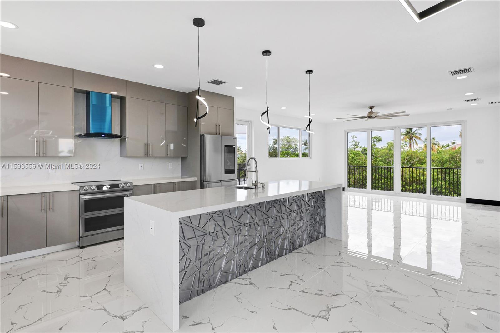 Dual convection ovens, quartz counters, vented range hood, and custom cabinetry