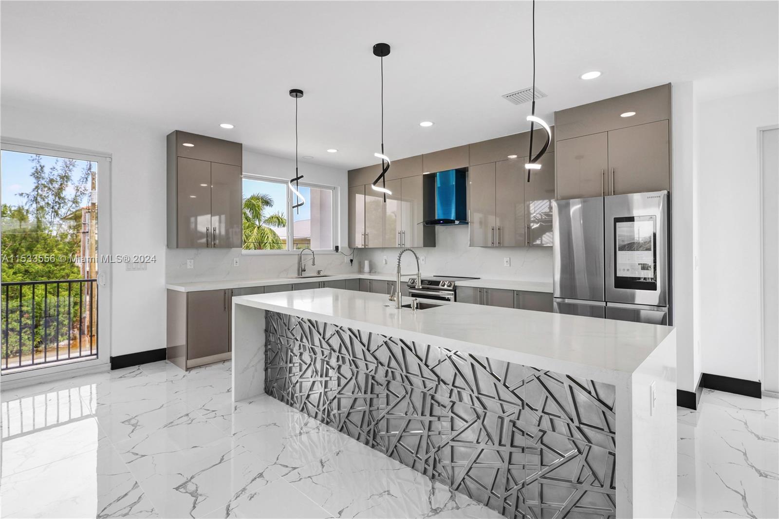 Dual convection ovens, quartz counters, vented range hood, and custom cabinetry