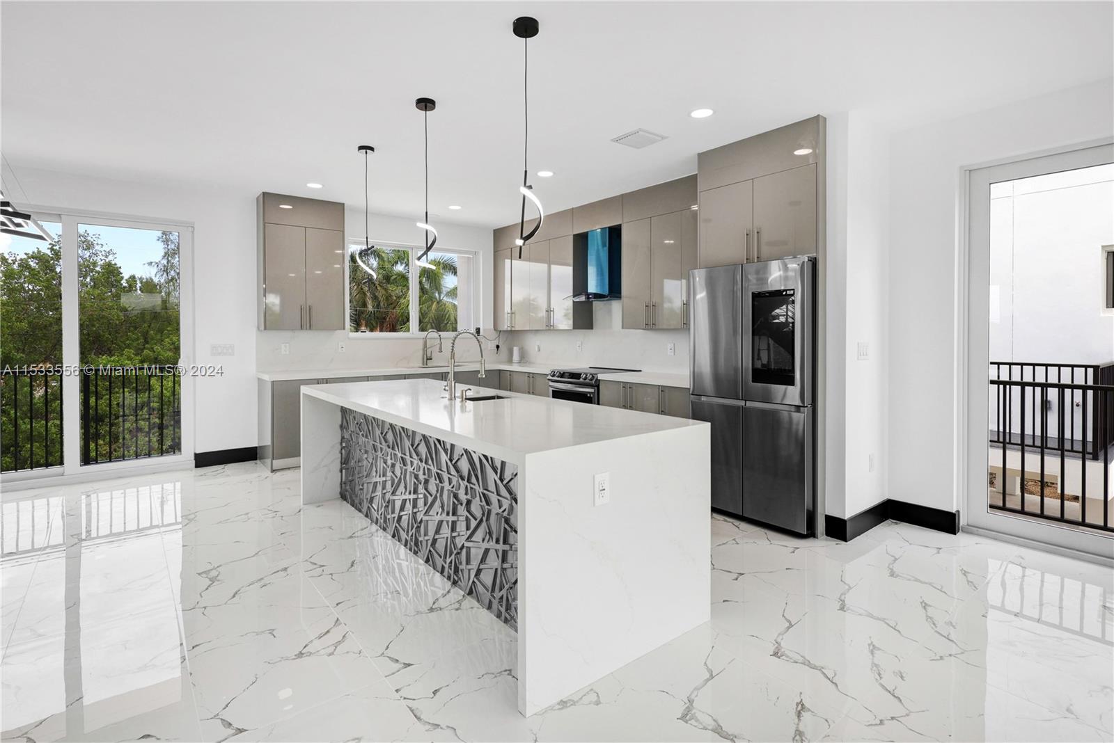 Dual convection ovens, quartz counters, vented range hood, and custom cabinetry