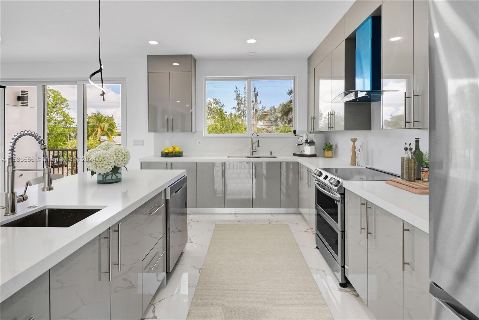 Prep sink, wine chiller, Smart Refrigerator, Dual convection ovens, quartz counters, vented range hood, and custom cabinetry