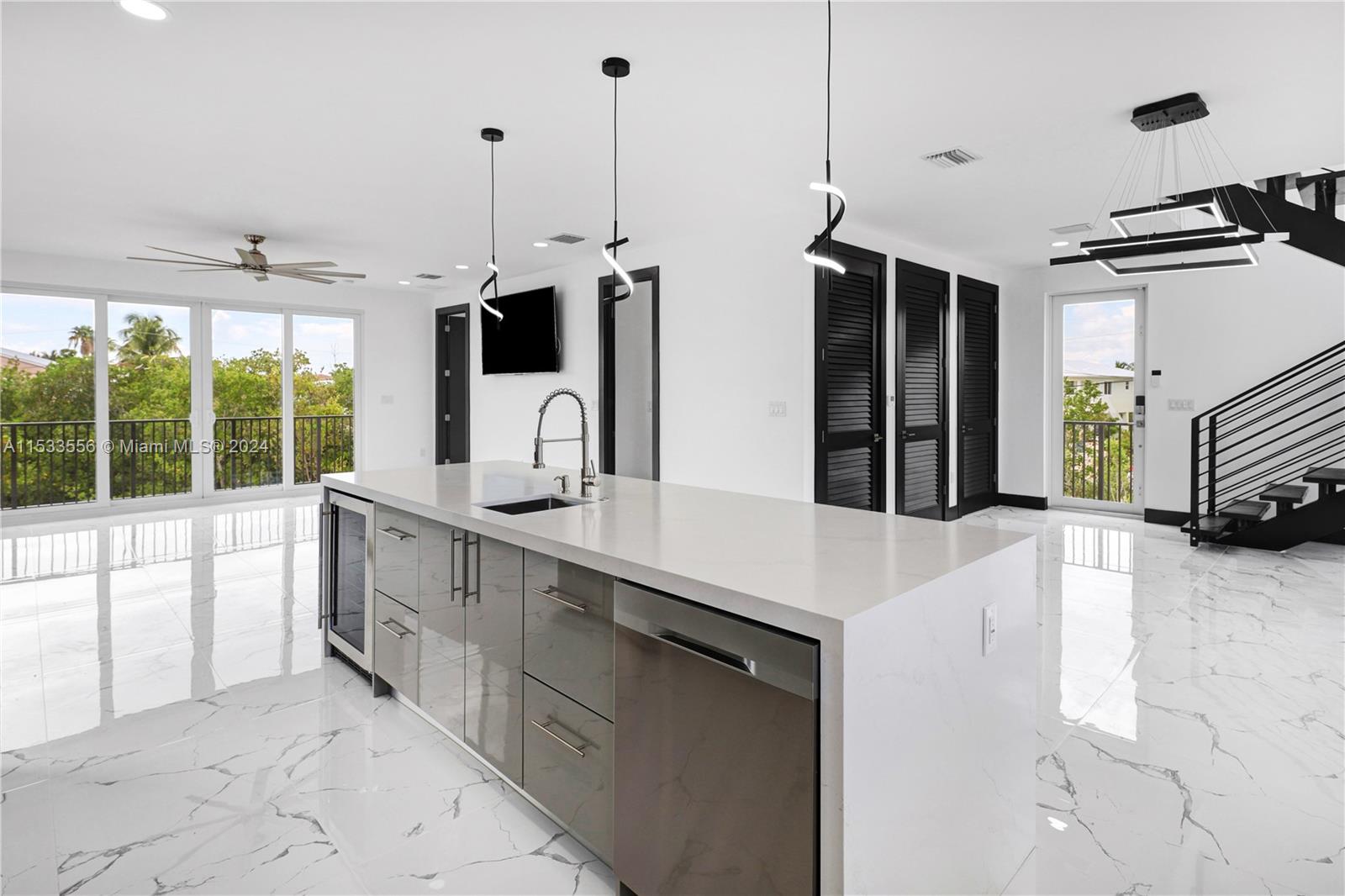 Center Island with wine chiller, prep sink and quartz waterfall countertops