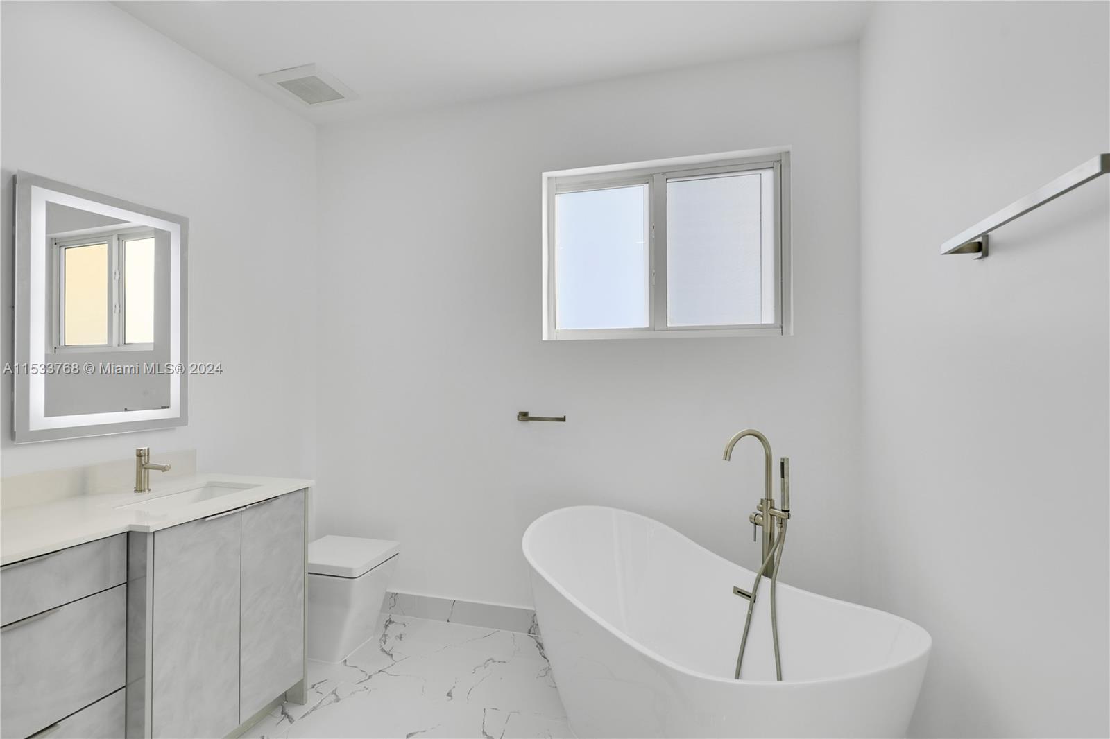 Stand alone tub, dual LED lighted vanity and custom shower with MOEN programmable controls