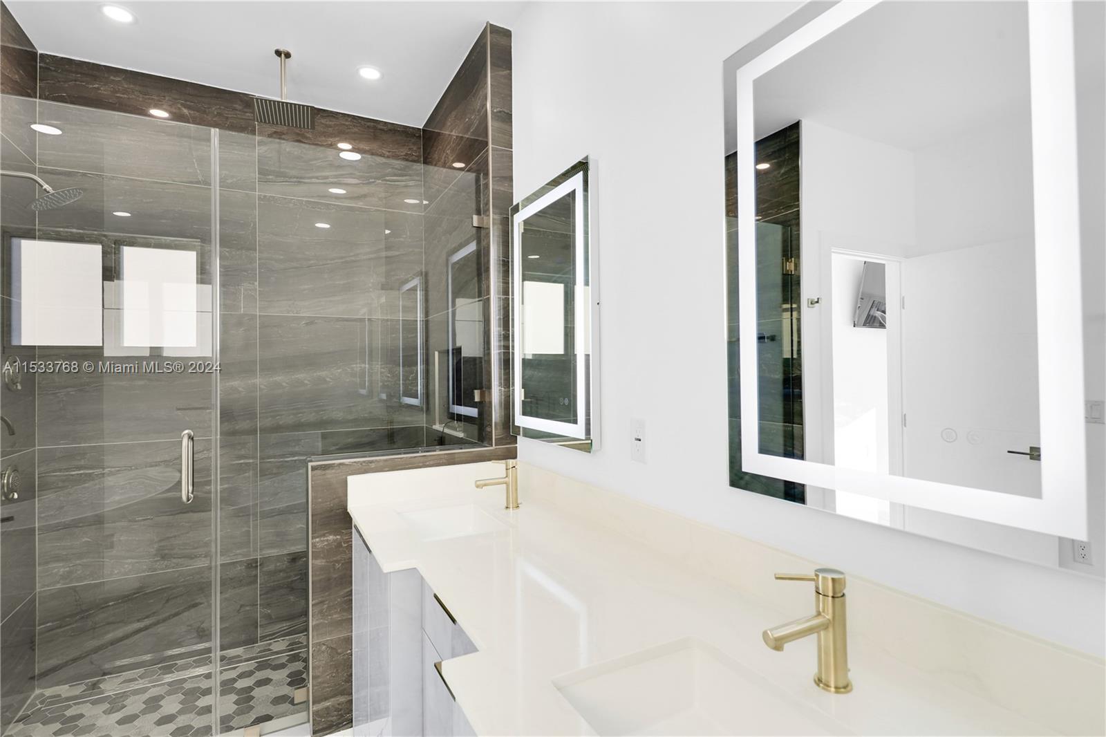 Stand alone tub, dual LED lighted vanity and custom shower with MOEN programmable controls