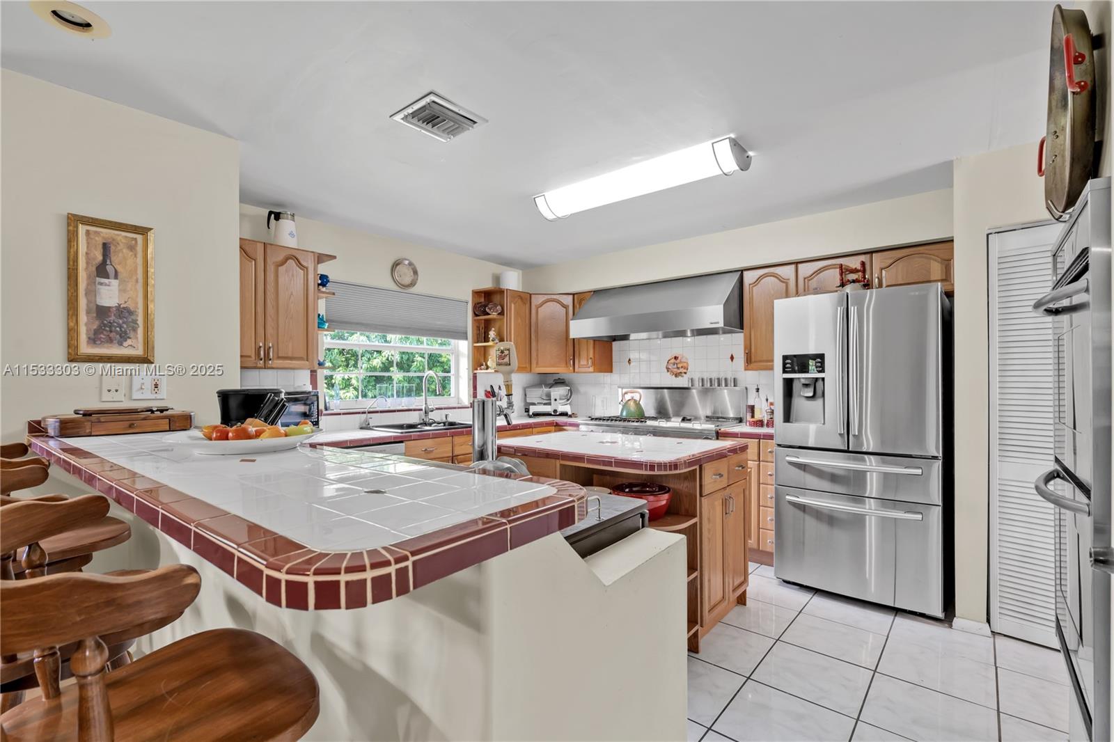 CHEFS KITCHEN W/ COMMERCIAL GRADE GAS STOVE, DOUBLE OVEN, CENTER ISLAND.