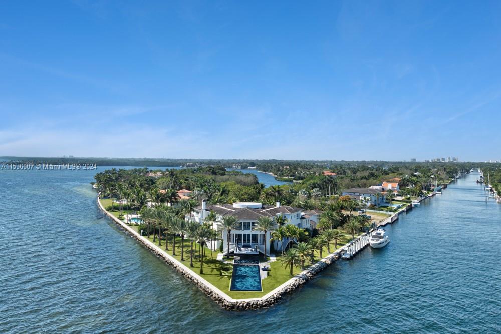41 Arvida Parkway with its 8 bedrooms, 9 baths and 3 half-baths, epitomizes luxury and bayfront living, on a unique 54,000+, v-shaped point lot with direct access to Biscayne Bay and the Atlantic Ocean. This architectural marvel, designed by Ramon Pacheco, offers 574’ of prime views, a private 140’ boat dock for yachting enthusiasts that can accommodate a 170+ foot mega yacht, 5 car garage, floor-to-ceiling windows, a fabulous Mick De Giulio kitchen, a stunning bayside, one-of-a-kind pool designed by Estudio Arque, landscaped gardens and multiple outdoor entertainment areas. This exclusive retreat, where open waters meet sophisticated living, is a haven for those seeking coastal elegance, security, privacy and access to nearby airports and the world!