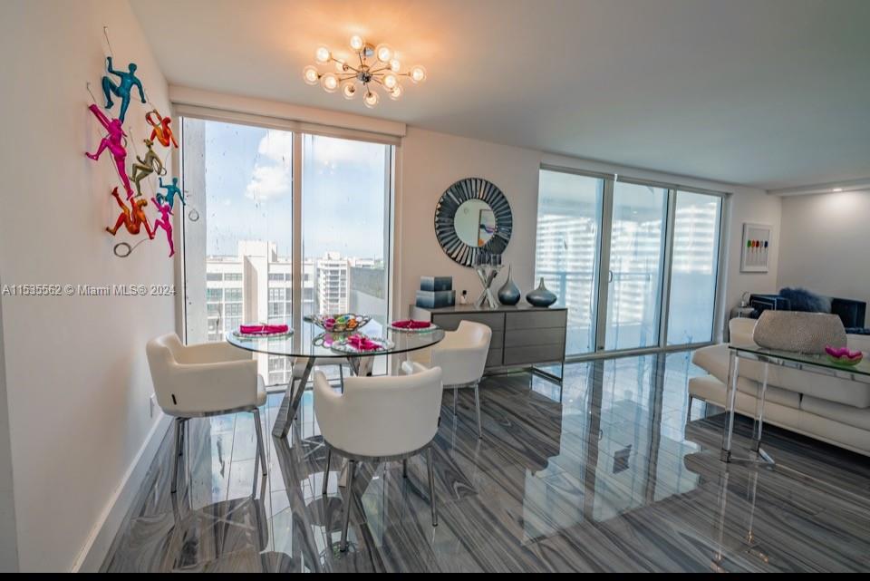 DINING LIVING ROOM AREA WITH FLOOR TO CEILING WINDOWS AND WIDE ICW VIEWS