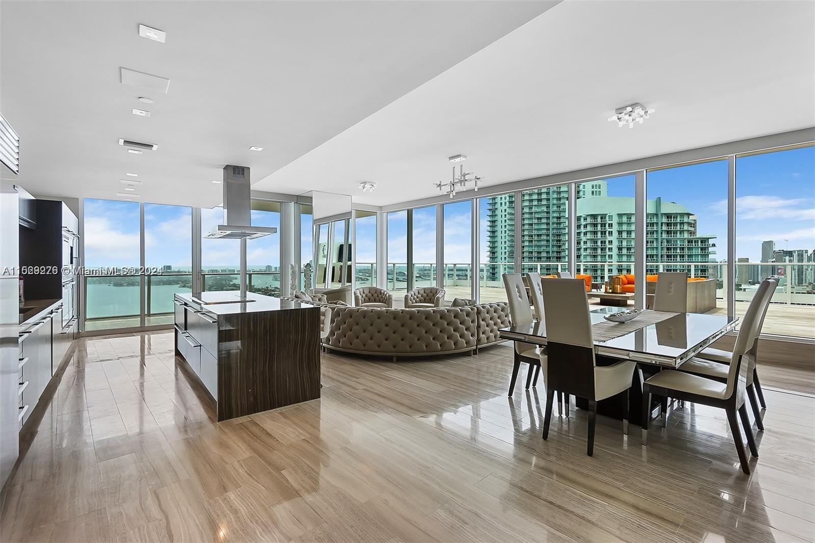 An absolute one of a kind designer Penthouse perched over Biscayne bay with sweeping 270 degree views from the Miami Beach shoreline to the downtown skyline; from Coconut Grove to the Hard Rock. In a world of cookie cutter Miami apartments, this glass jewel box stands alone. With 2,700 sqft of interior space and over 2,500 sqft of sprawling terrace directly off your great room, it is a unicorn that is seldom seen. Imagine the beauty of opening your glass sliders to an immense outdoor living space replete with a jucuzzi hot tub and outdoor kitchen. A home in the sky filled with designer finishes, a spectacular glass primary bath, oversized walk in closets and a gorgeous chefs kitchen and entertainment island. It's one of those spaces that must be experienced in person to be believed