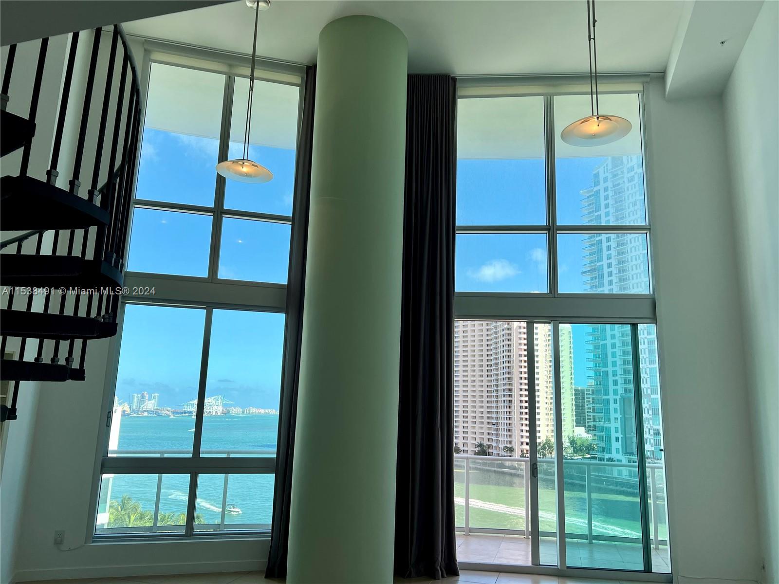 Dramatic & impressive views of Bay and River! Two story LOFT w/amazing 19" high ceilings to catch 180 degrees of awe inspiring sunrises & water views! Best line in the building! Many upgrades: built ins, closets, lighting fixtures, window treatments, etc. Walking distance to Whole Foods, Bayside, Brickell, Metro mover, Novikov Restaurant and Joe & The Juice downstairs plus 17-screen Silverspot Cinema and Brickell City Center. Park your car in the same level of the unit. Building offers luxurious life style, 24-hr front desk attended. Chic downtown living at its best! Pool is currently closed until further notice.