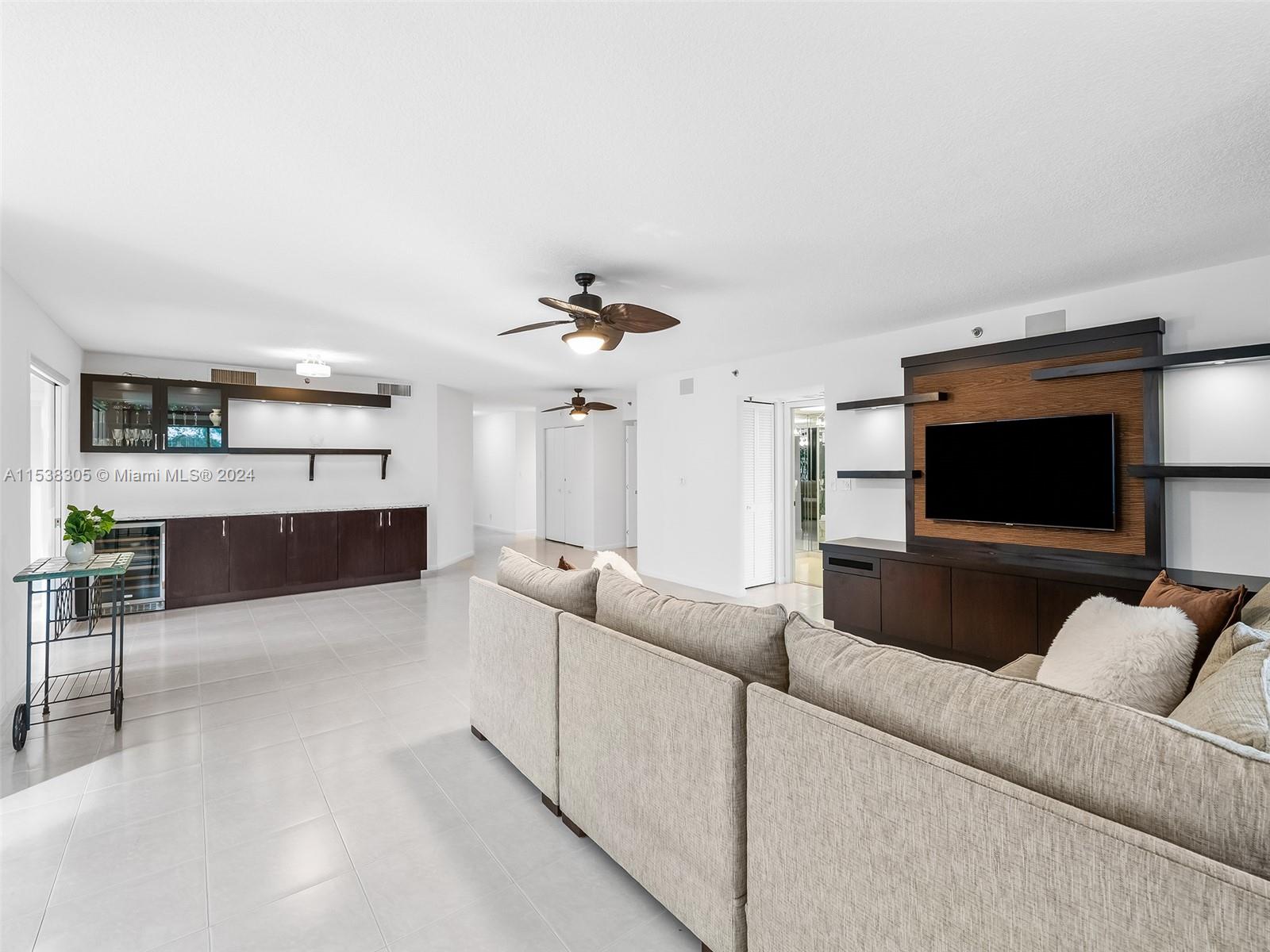 Expansive living room with beautiful built ins and a wine fridge