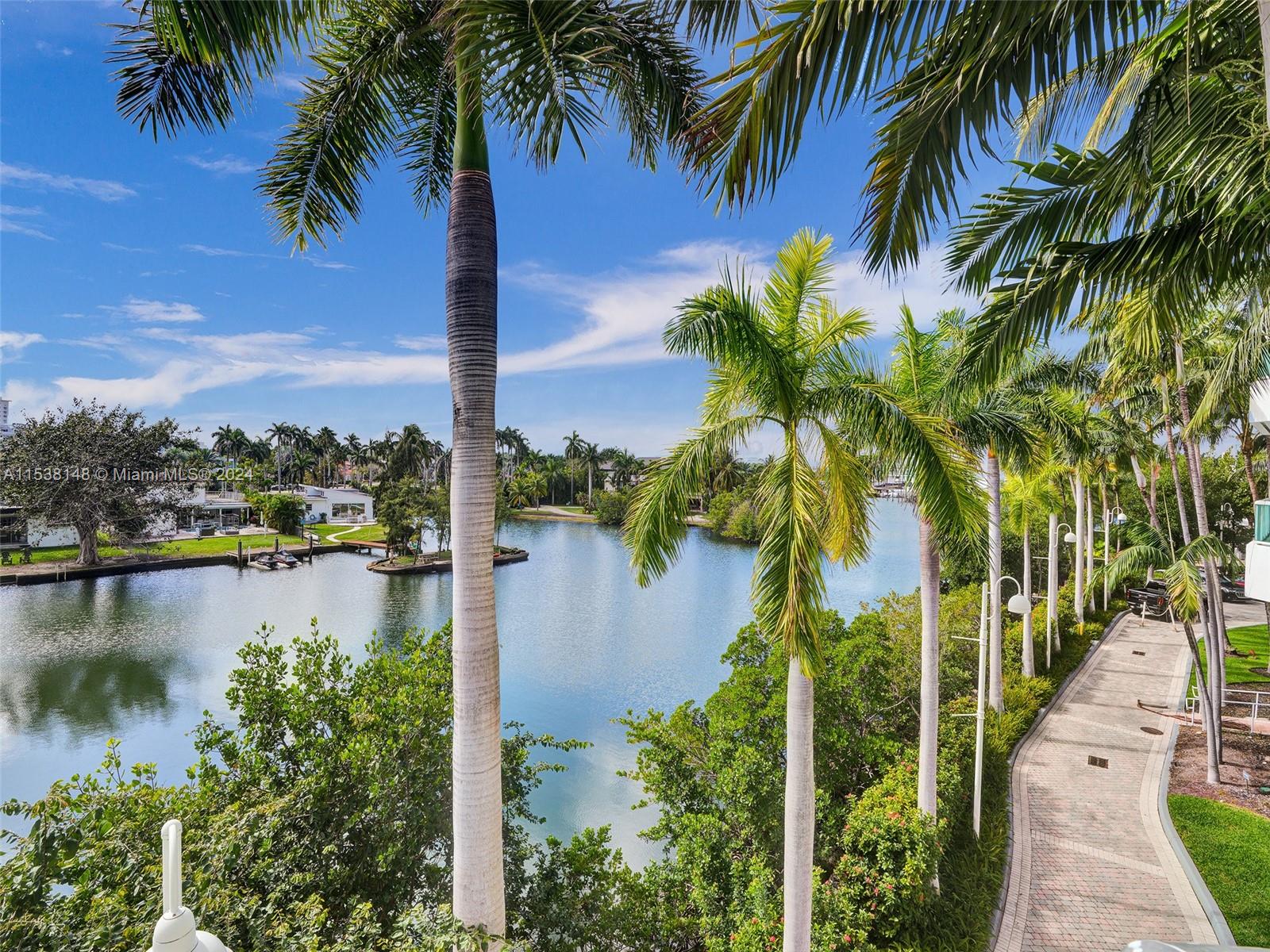 Live in your own waterfront tri-level home in paradise! This corner home boasts spectacular views from 4 terraces. 4 bedrooms plus den-hobby room/maid room, 4.5 bathrooms, and a private garage! 3 stories, large spacious and high ceilings, over 3,500 sqft. with top of the line amenities— beach club access, spa, gym, tennis courts and even boat dock availability! A true gem of a property. The perfect mix of a home and a condo, privacy without the maintenance; yet with all the amazing amenities of a luxurious building.