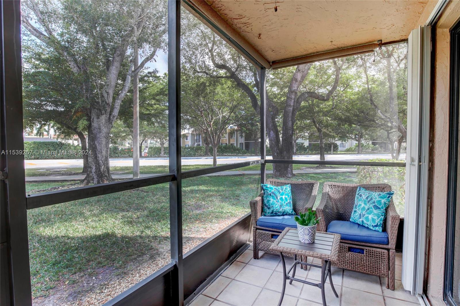 Back screened in porch with roll down shades & fan