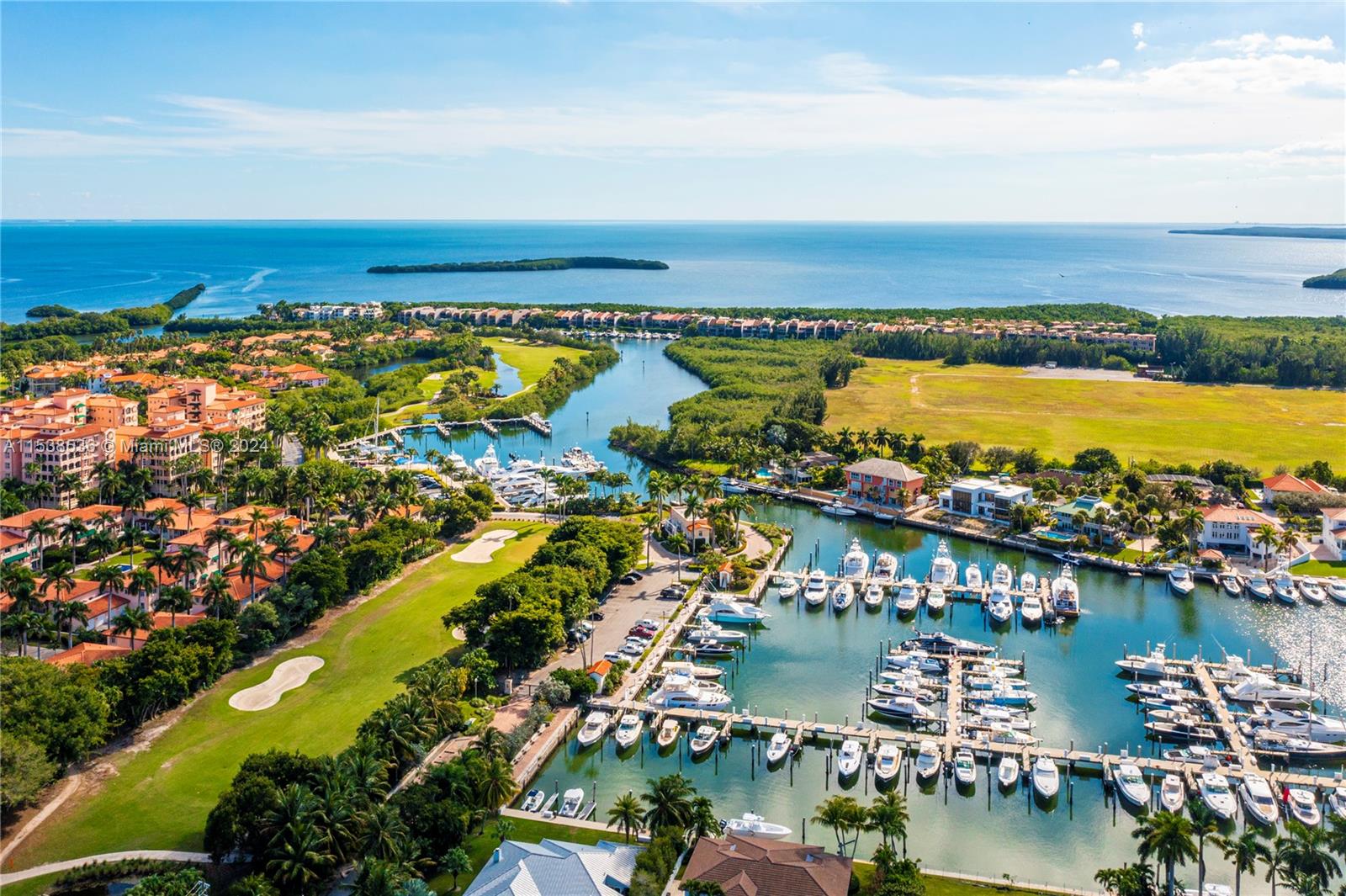 Discover paradise amidst palm trees, the serene marinas, and the lush greenery of the Arnold Palmer Golf Course at Deering Bay Yacht & Country Club. This prestigious gated community unveils the exquisite Padua corner residence, spanning 4,220 SF with 4 beds and 4.5 baths plus den. Delight in the 180-degree wraparound balcony, offering panoramic views of the lagoon, marina, tropical landscapes, and Biscayne Bay. Deering Bay's magnificent 30,000 square-foot Clubhouse presents a superlative dining and service experience, featuring exquisitely crafted cuisine savored within a serene setting. At a private tennis club, members are able to enjoy 7 Har-Tru tennis courts. Embrace the gorgeous sunrise every day, surrounded by unparalleled beauty and nature! Your amazing new lifestyle awaits!