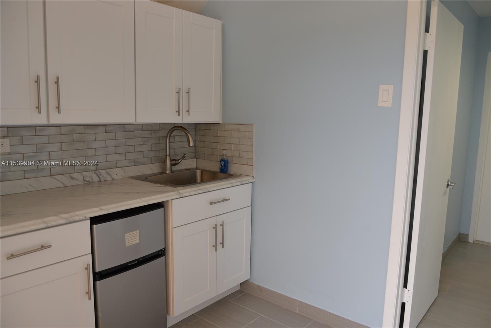 Pool side cabana with sink , fridge , shower and toilet.