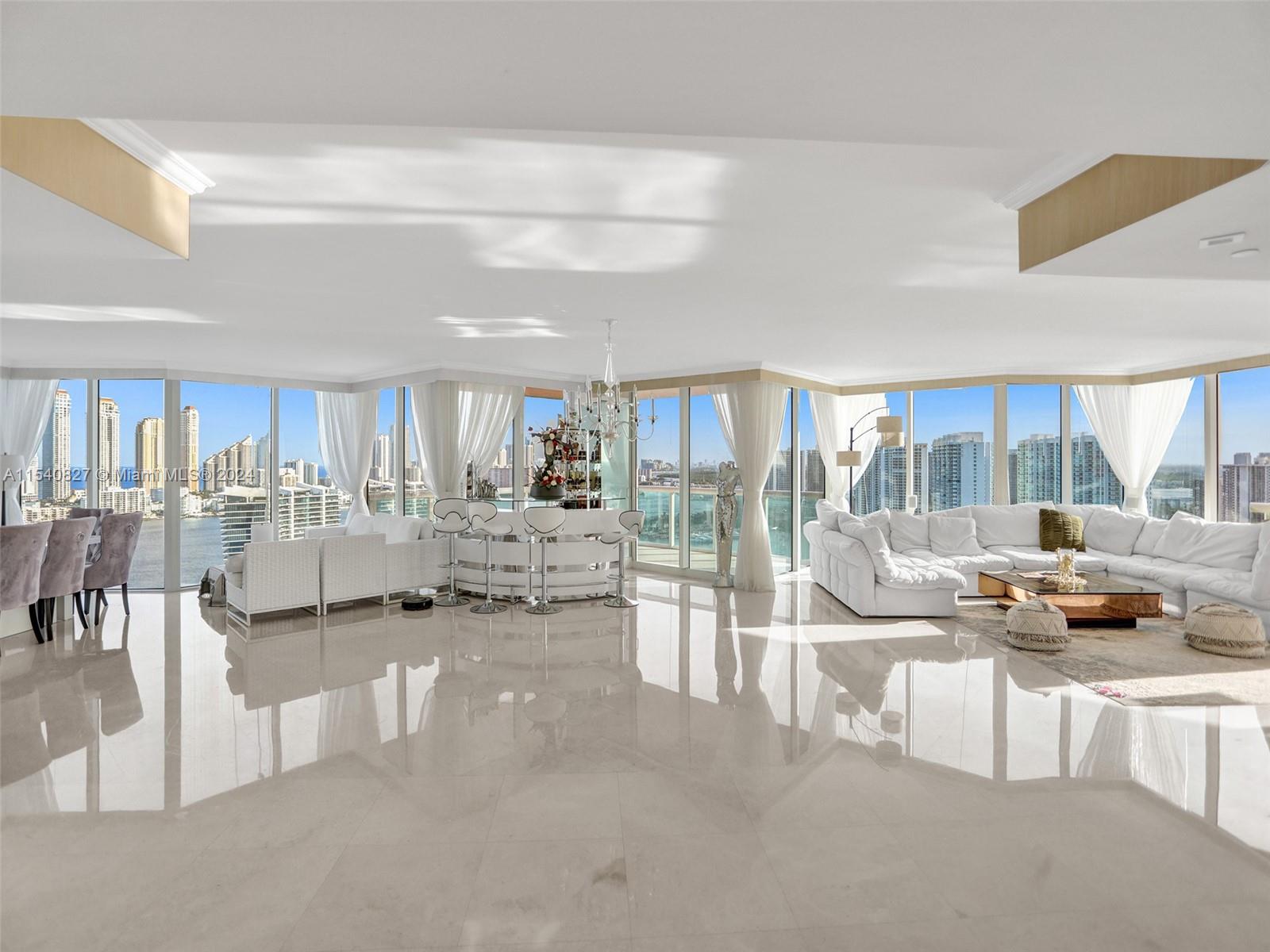 Extraordinary 28th floor PH, this one-of-a-kind 4-bedroom, 4.5-bath Aventura Penthouse presents an exceptional fusion of luxury and location. Offering breathtaking sunrise-to-sunset views of the Atlantic Ocean and the serene Intracoastal, this one-of-a-kind residence boasts the luxury of a private elevator, an open floor plan adorned with high-end finishes, Walk-in closets, and elegant marble flooring. Rarely available, this Penthouse comes with 3 parking spaces in the garage. The complex offers an array of amenities, from tennis courts, and a pool,  to a private marina and a bustling clubhouse, all securely gated. Immediate proximity to the renowned Aventura Mall, ocean, fine dining, and shopping adds to the allure, making this an unparalleled opportunity to experience life at its best.