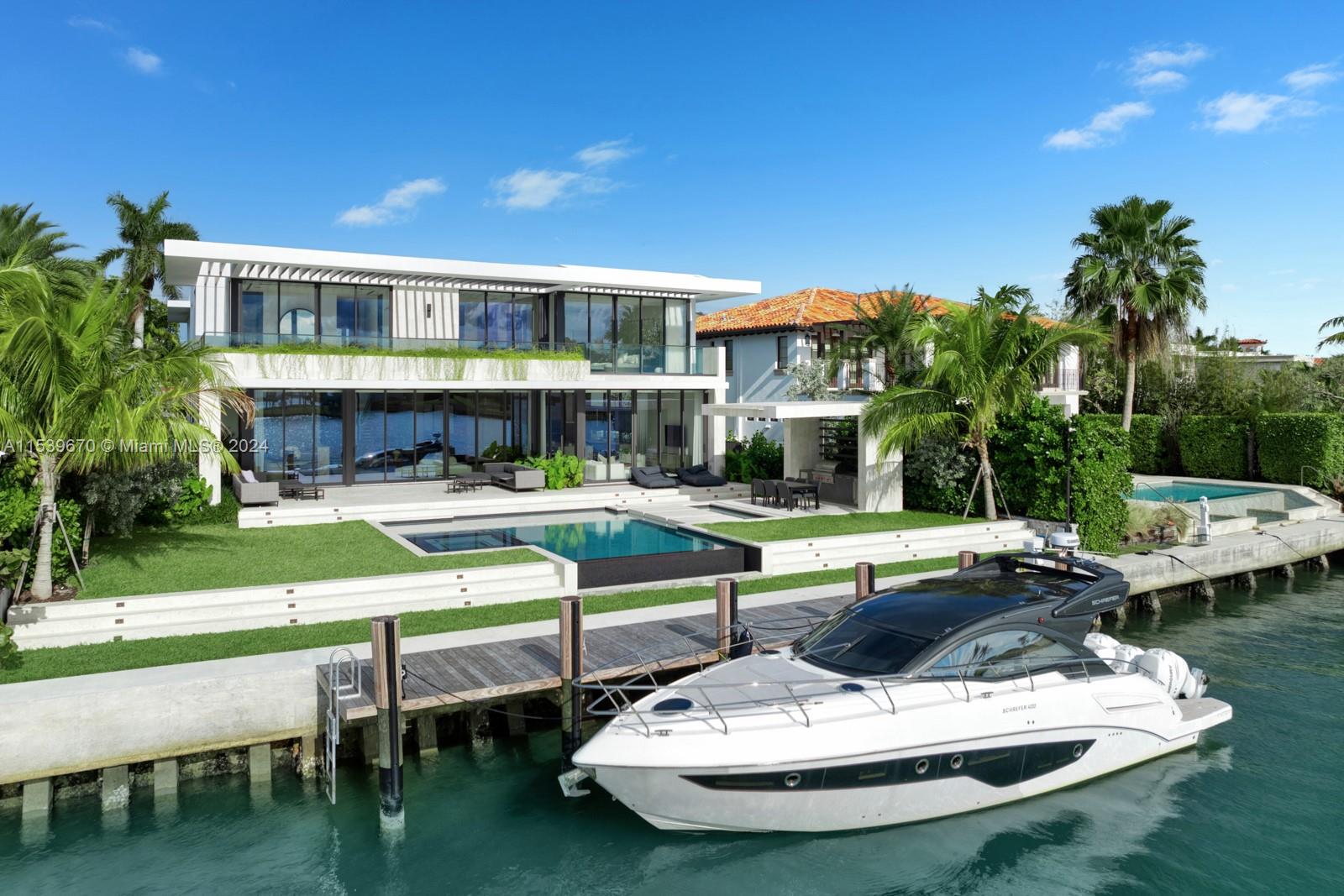 This brand-new modern masterpiece is situated on the SW edge of Bay Harbor Islands, overlooking Indian Creek. Western exposure makes this the perfect home to enjoy the most beautiful sunsets in Miami. Meticulously crafted by SDH Studio Architecture & Interior Design, it offers the perfect blend of luxury, comfort, & style; featuring custom millwork, high-end finishes, & an abundance of natural light. The open floor plan creates a seamless flow throughout, envisioned for entertaining. The gourmet Mia Cucina kitchen is equipped with Subzero & Wolf appliances, custom cabinetry, and a quartz island. Access the chef’s kitchen behind hidden pantry doors for additional prep and cooking space. The exterior offers 80 ft of waterfrontage, pool, spa, summer kitchen, & covered lounging & dining areas.