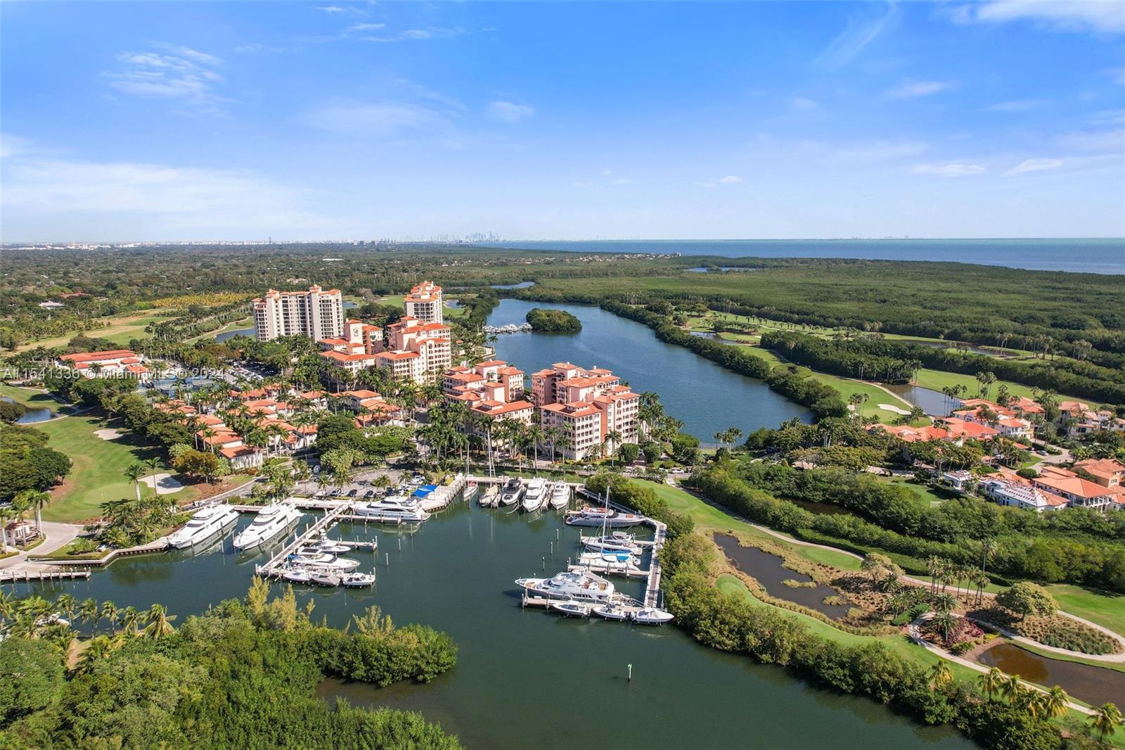 Welcome to this spacious ground-floor corner unit featuring 4 beds, 3.5 baths, plus Office in the guard-gated Coral Gables Community, Deering Bay. Upon entering through the foyer, you'll find an open floor plan connecting to the spacious kitchen with a breakfast nook. The wraparound terrace offers unobstructed views of the lagoon, providing a serene retreat. The Primary Suite has a private balcony, walk-in closet, and spa-inspired bath, ensuring residents enjoy a tranquil sanctuary. Amenities include a gym, pool, and 2 parking spaces. With the Marina, Clubhouse, and prizewinning Golf Course just steps away, residents have easy access to recreational facilities. Club Membership is available to enhance the resort-style living experience, adding a touch of luxury to this exceptional property.