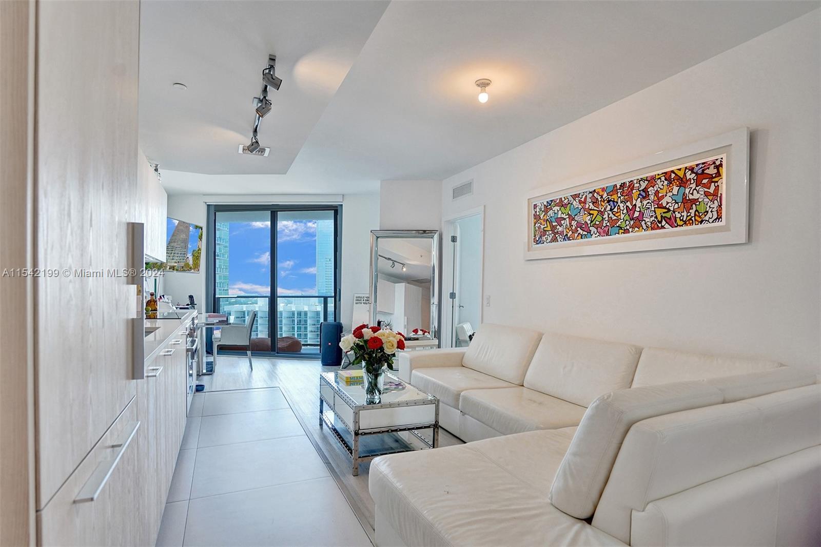 Modern building in hip, trendy Edgewater. 1 Bedroom + Den and 1 1/2 baths with spectacular city and bay views from the 23rd floor. 9-foot-high ceilings with floor to ceiling hurricane proof windows. Kitchen with Bosch appliances, quartz countertops, washer and dryer inside the unit, window treatments, closet cabinetry, and ceramic floors throughout including the oversized balcony. 
Paraiso Bayviews offers 5-star resort amenities such as movie theater, gym, spa, business center, rooftop pool with grill area, sunset pool, lighted tennis courts, boardwalk, and an incredible beach club with Amara restaurant from acclaimed chef Michael Schwartz. Walking distance to Midtown and Design District.
