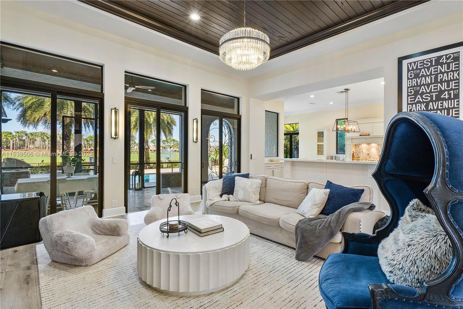 Living room with view of outdoor patio and kitchen