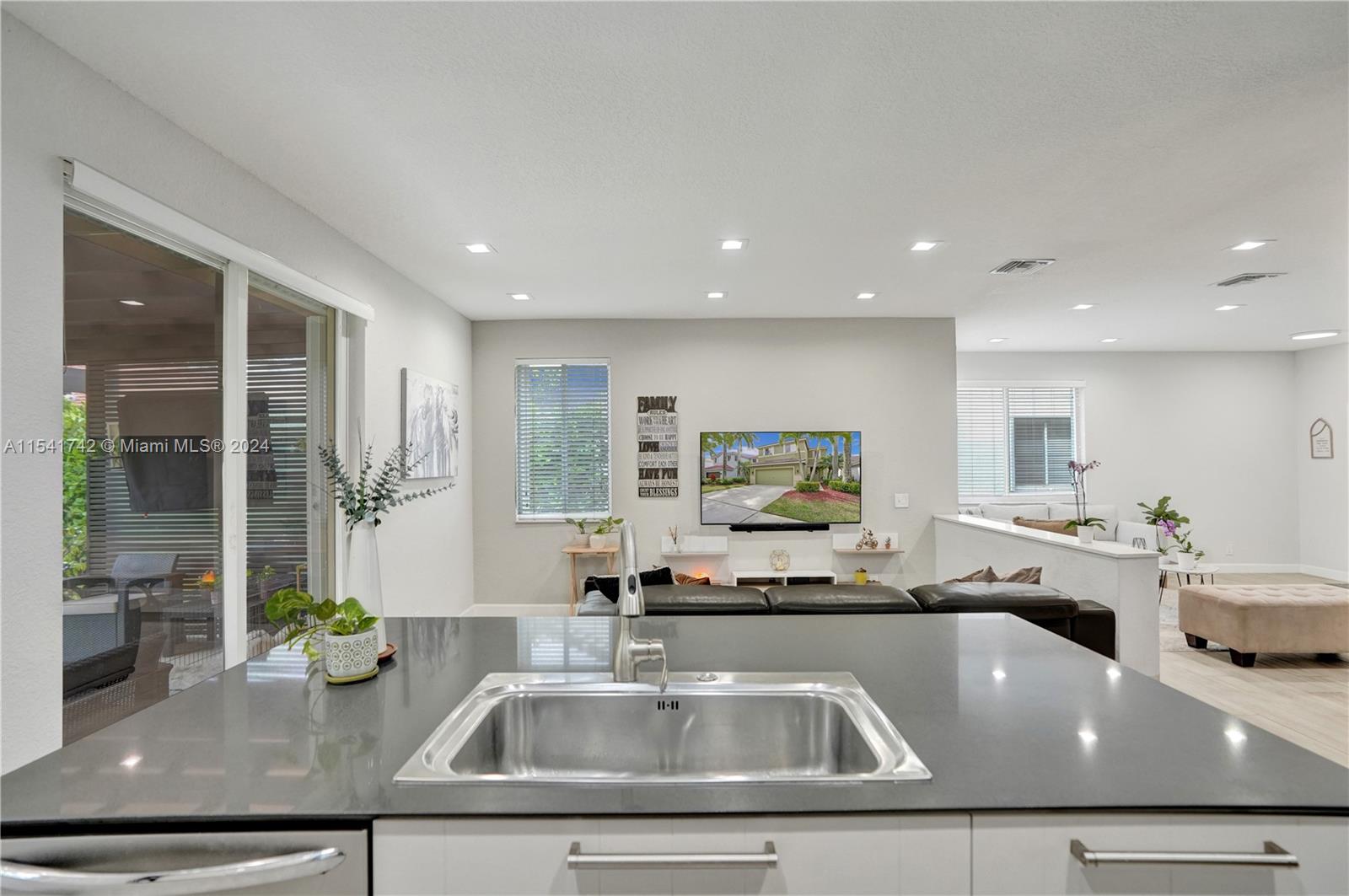 open kitchen with island and a nice pull out drawers pantry