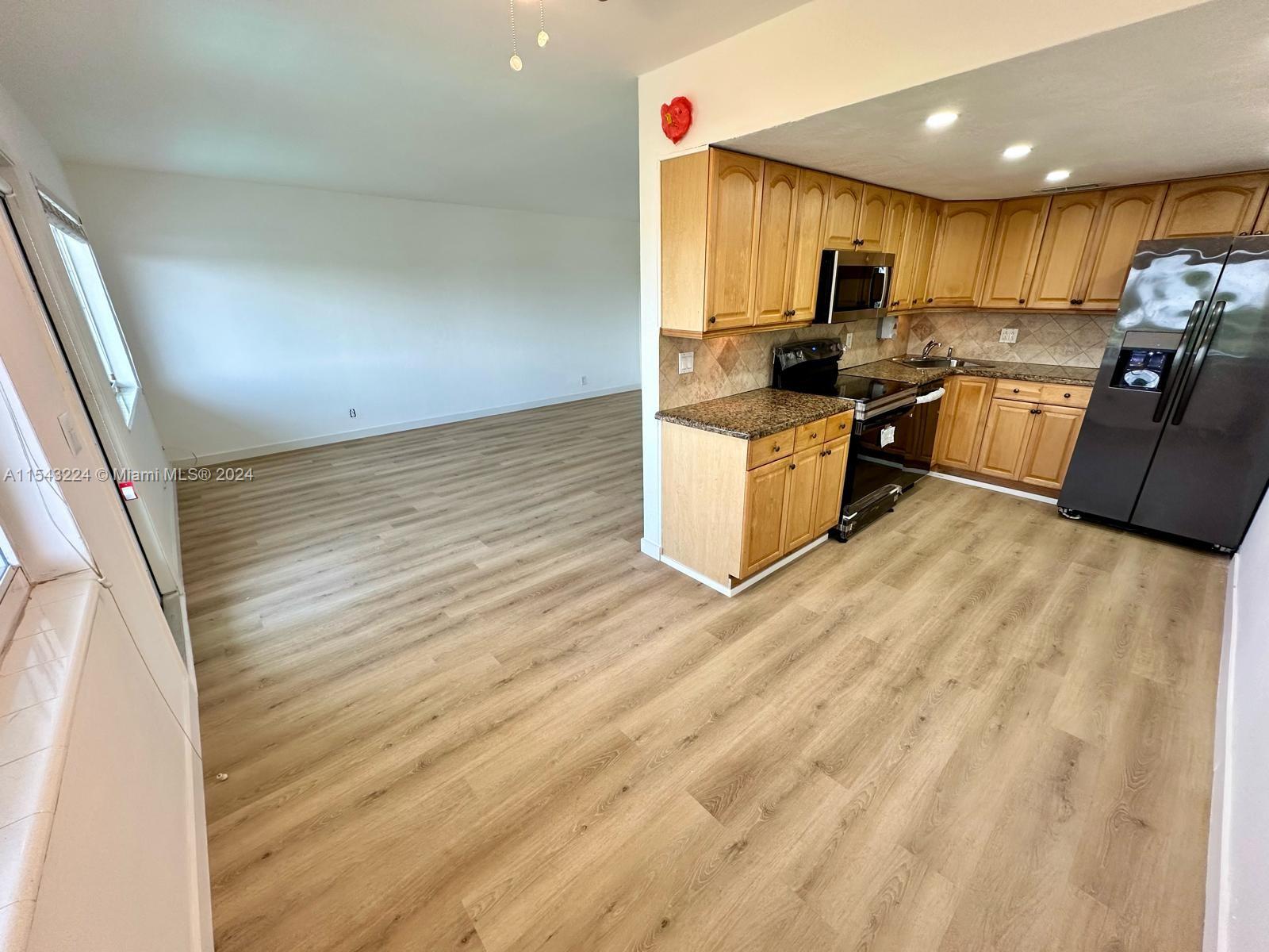 Large kitchen, dining area and living room