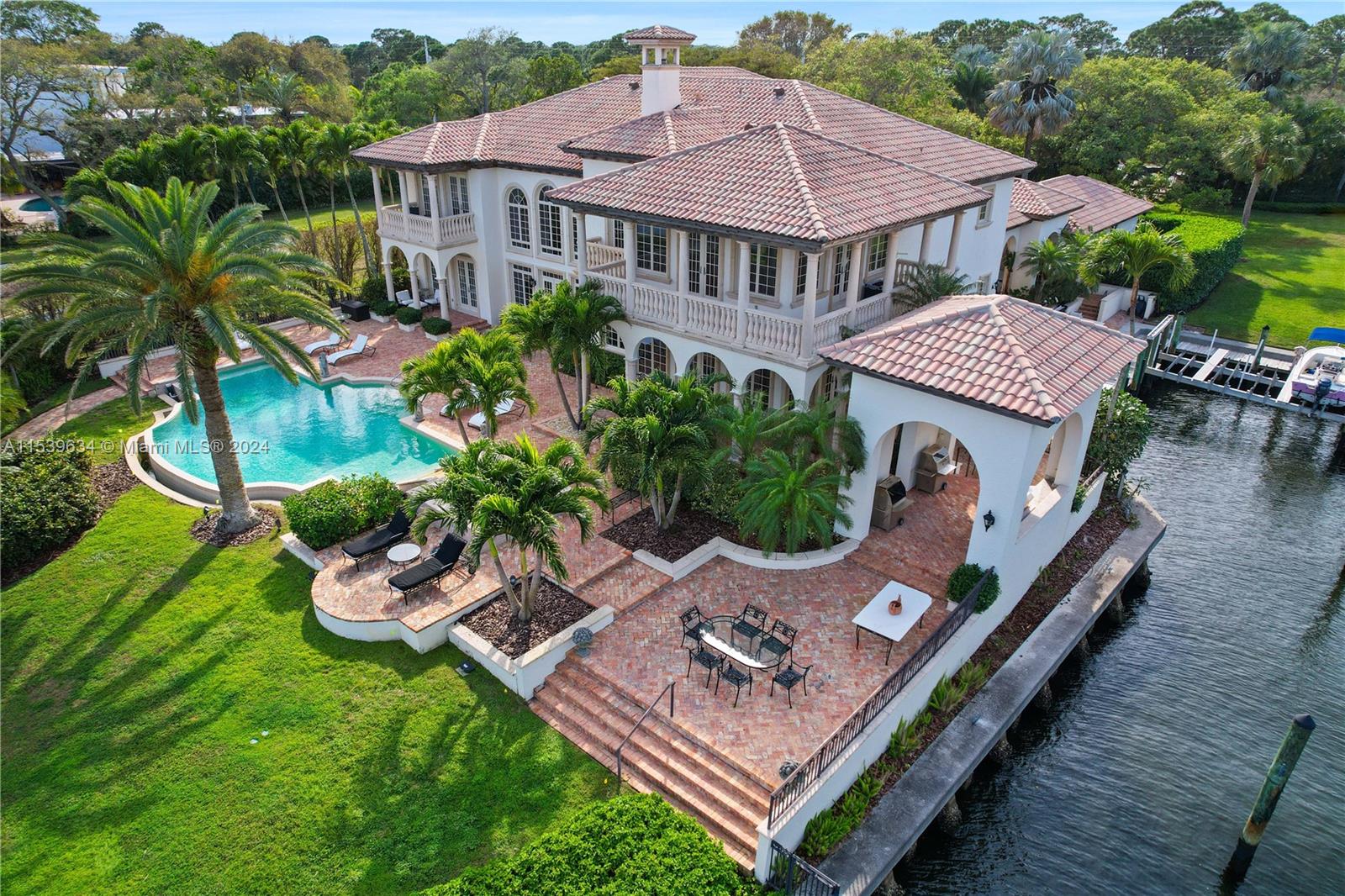 This real estate offering presents an exceptional opportunity to own a waterfront estate with over 2 acres of land and 300 feet of direct Intracoastal waterfront. With 4 parcels included, there is potential for expansion and customization. The private yacht basin provides ample space for your yacht and other personal watercraft with convenient access to the Atlantic. The residence features 4 bedrooms, 4.5 bathrooms and expansive living spaces designed for indoor-outdoor living. The gourmet kitchen, renovated in 2023, is equipped with top-of -the line appliances, quartzite counters, custom cabinetry, and 2 spacious islands. Conveniently located to fine dining, cultural attractions, world class golf, and other recreational activities.