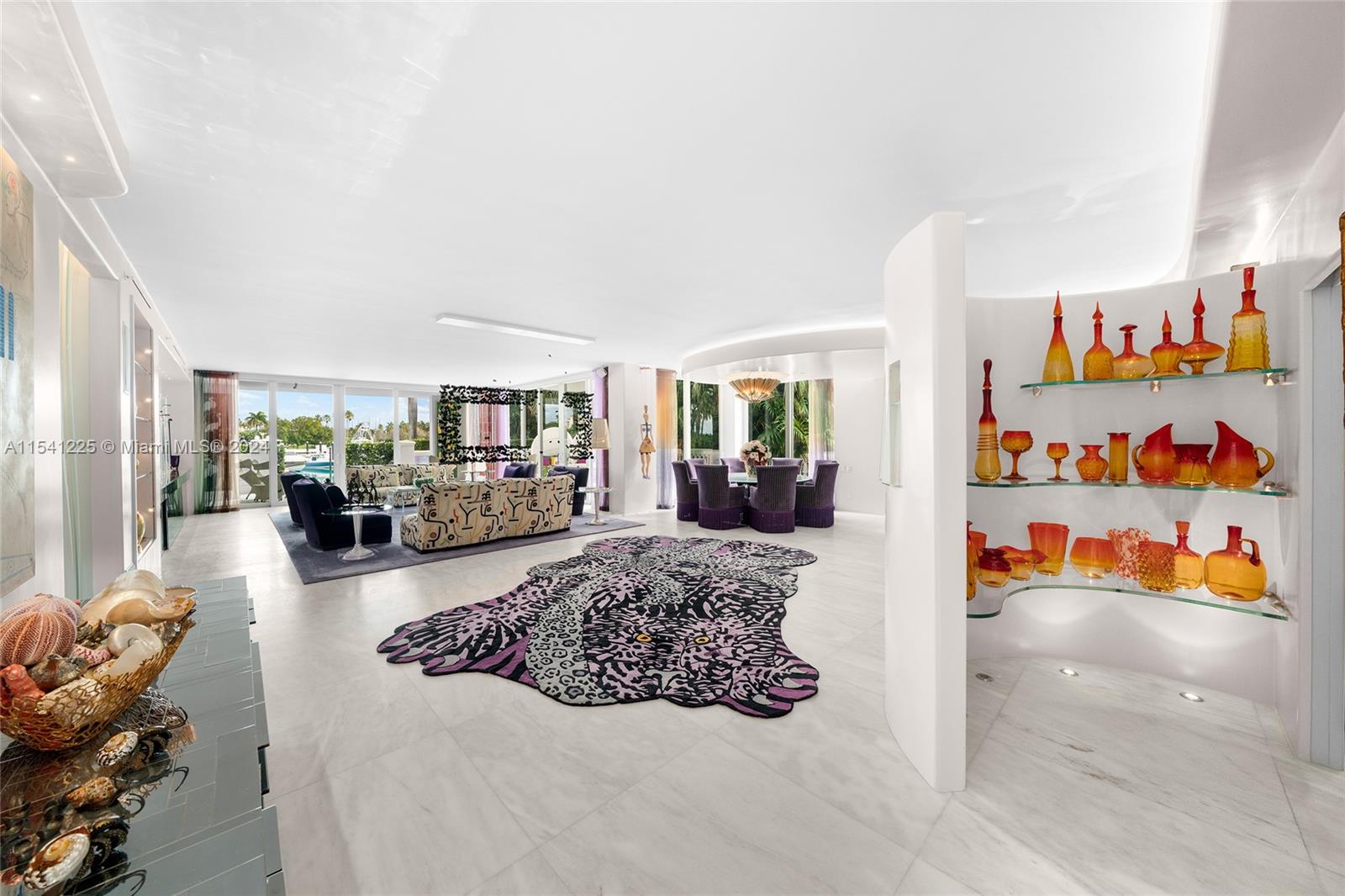 This spectacular one-of-a-kind 2-story townhouse is located in Harborview overlooking Fisher Island’s inner marina. Home features 4BR/4+1BA & over 6,000 SF of living area, marble & rich hardwood floors, glass doors, ceiling/wall accents. 1st floor offers a spacious living & dining layout & access to an expansive wraparound terrace w/direct marina views, sleek chef’s kitchen, sumptuous principal suite & luxurious spa-inspired bathroom. 2nd floor features an large open floor plan, family room w/home theater, soaring vaulted ceiling & dining terrace overlooking the marina. Fully equipped gym, dining space, a kitchen, plus 3BR/3BA. Amazing location-access to path near all the best Fisher amenities. Garage parking - 4 cars & 4 golf carts. 72’ dock right behind unit can be acquired separately.