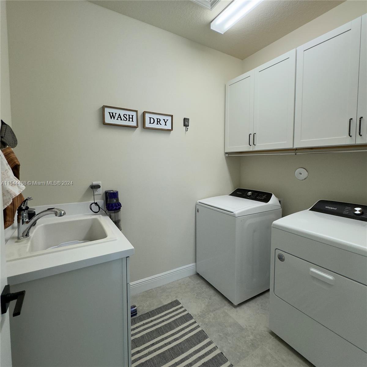 Above W & D cabinets in laundry room