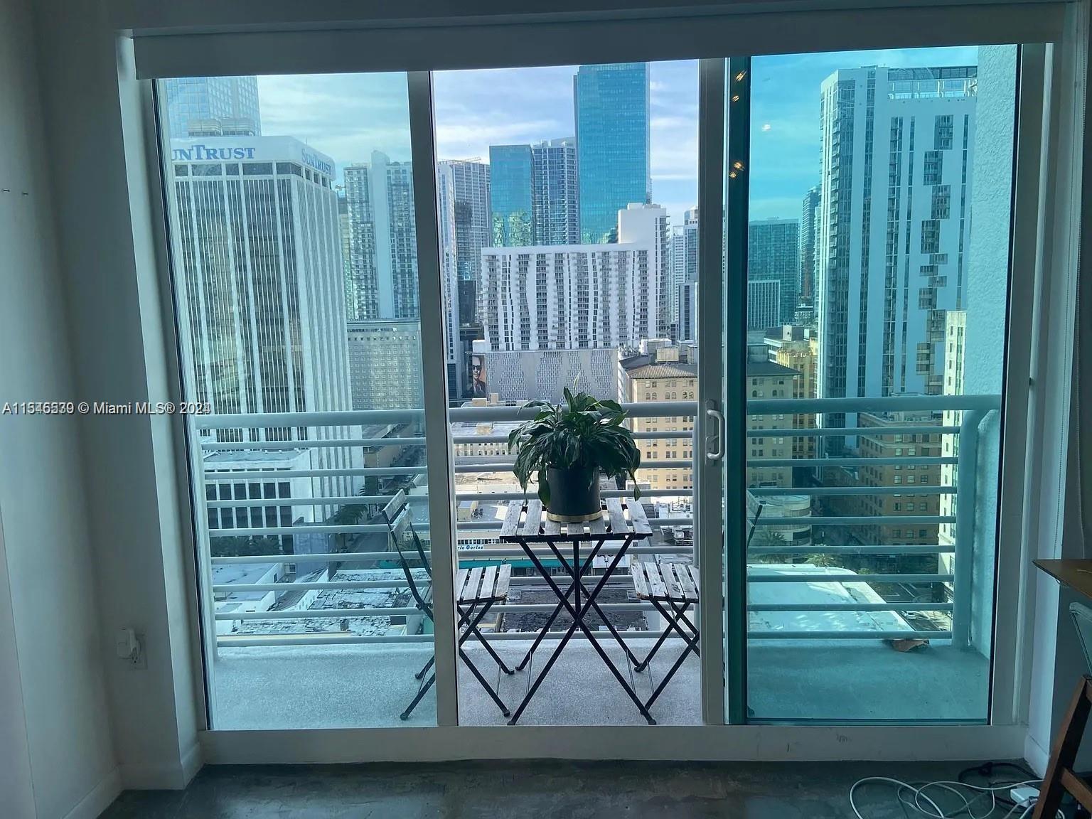 Gorgeous skyline view from living room with balcony