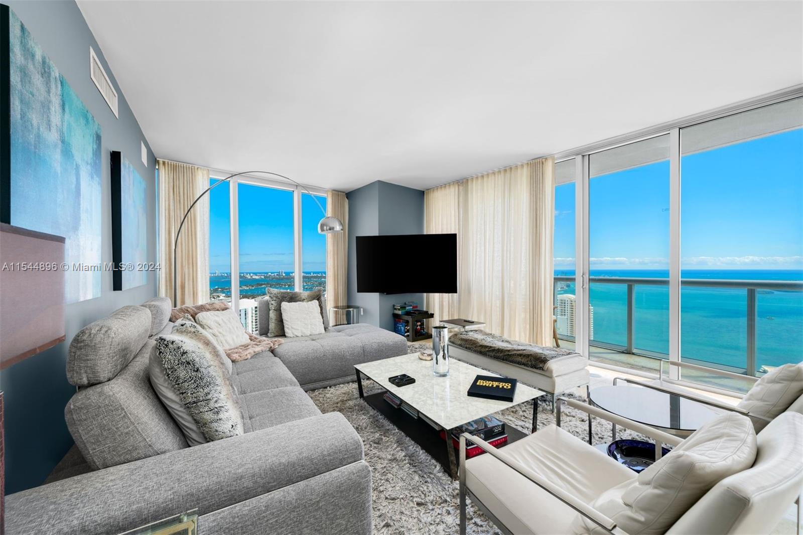 A magnificent combination residence located on the 53rd floor of Icon Brickell Tower 1 w/ 5 bedrooms, 4.5 baths, 2 kitchens, 2 laundry closets, 2 assigned parking spaces, 3090 int sq ft, 451 sq ft of balcony, and 10-ft-high ceilings w/ sweeping views of the bay, city, ocean, and river. Connected by an adjoining door, the 2 units feature marble flooring throughout the main living areas, wood flooring in all bedrooms, and high-end kitchen appliances by Wolf & Sub-Zero. Building amenities include a 2-acre pool deck w/ a 50-person hot tub & 300-ft-long swimming pool, fitness center, full-service spa w/ sauna & steam rooms, on-site restaurants, valet parking, and full-service concierge. Within walking distance of Whole Foods, Silverspot Cinema, Mary Brickell Village, and Brickell City Centre.