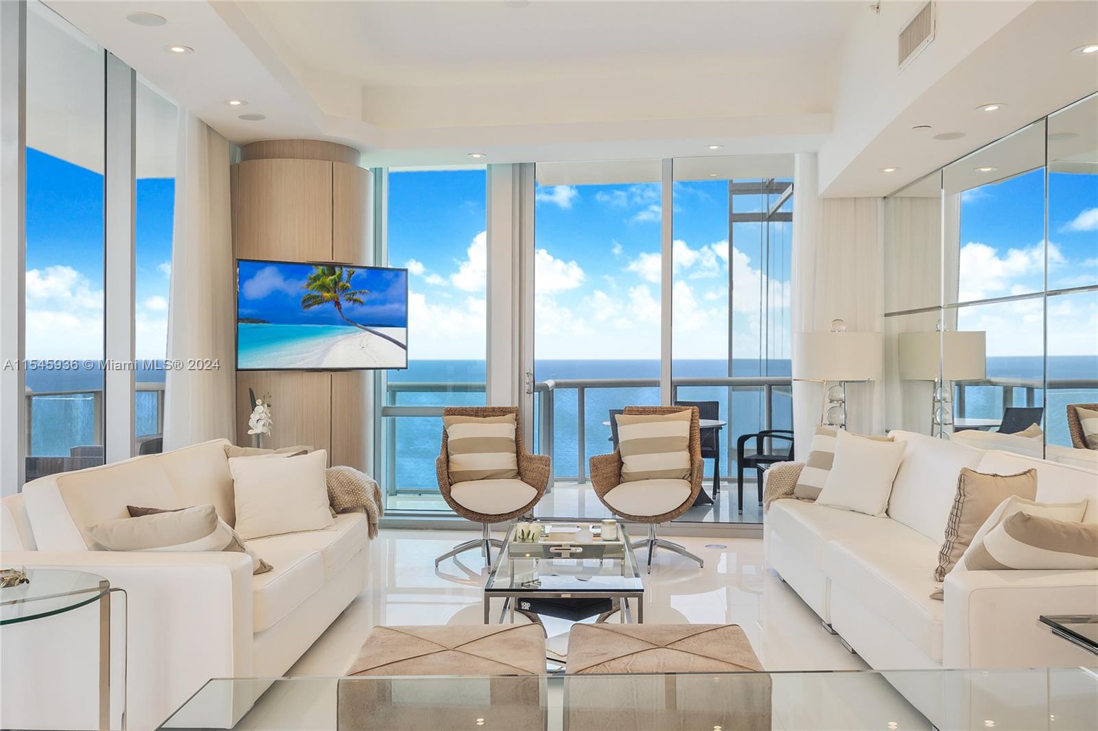 Stunning Corner Unit with Direct Ocean, Bay, and City Views! 3 Beds, 3 Full Baths, 1 Half Bath for Guests, in Sunny Isles Beach's Most Luxurious Building by Architect Carlos Ott! Featured in DECOR Magazine, this unit was Professionally Decorated by INFINITY DESIGN, helmed by Ronny Constansi. Boasting a Spacious 1,956 SF, Vast Terraces, Private Elevator Entry, Breathtaking Floor-To-Ceiling High-Impact Glass Windows, Smart Home Technology, Automated Window Treatments, Surround Sound, Marble Floors, and Top-of-the-Line Appliances. Offered Furnished or Unfurnished. Amenities: Two Edge Infinity Pools, Fitness Center, Private Cinema, Children's Playroom, 24/7 Concierge Services, Private Beach Club, and Spa with Lounge Area. Experience Luxury Living in Sunny Isles Beach's Prime Location!