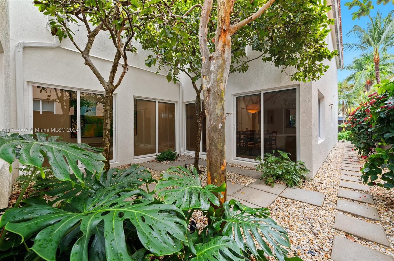 The private courtyard sits along the walkway and dining room. The backyard is in.....the back!