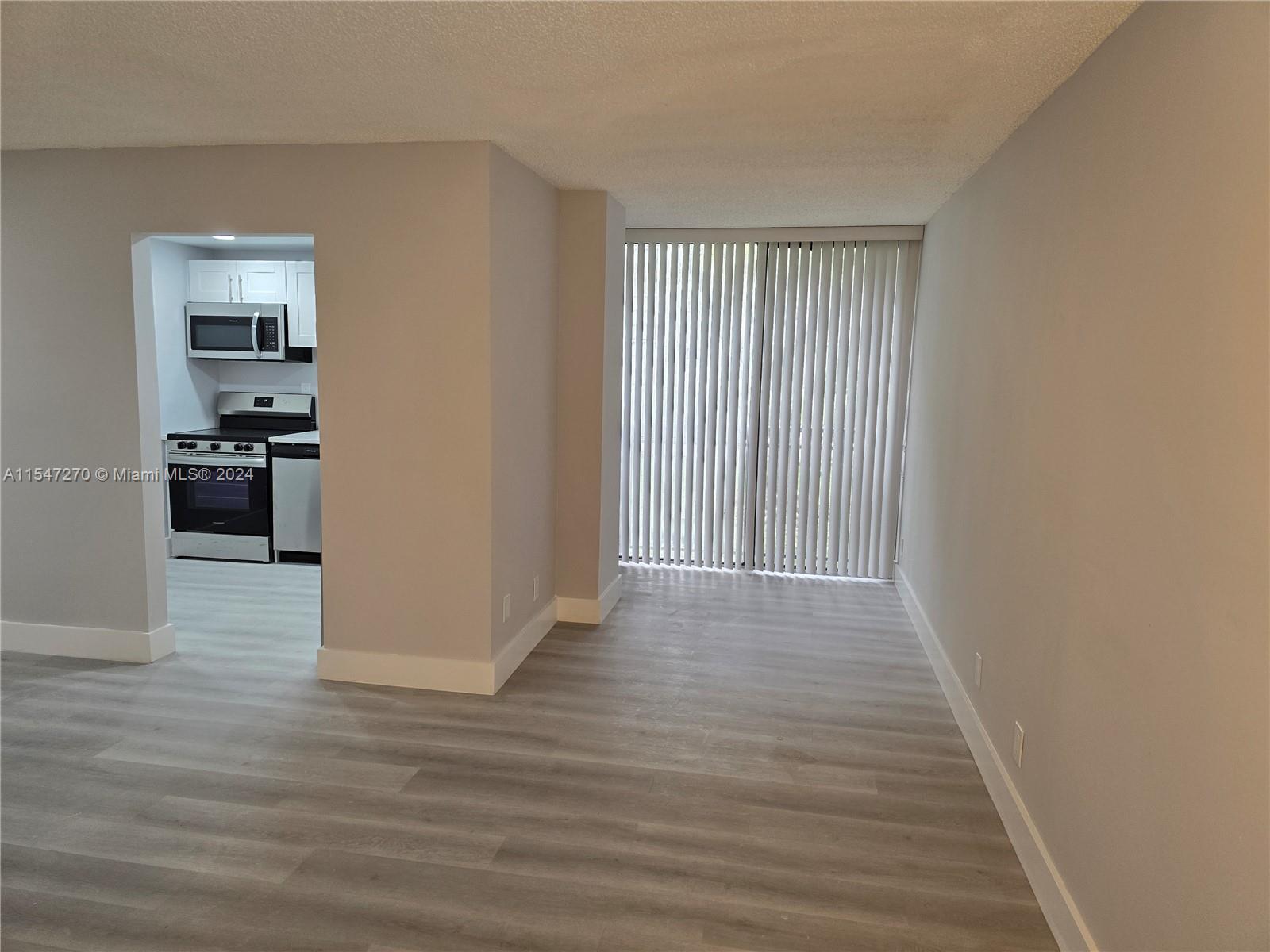 Partial View of Living Room, Entrance, and Hall to Bathroom and Bedrooms