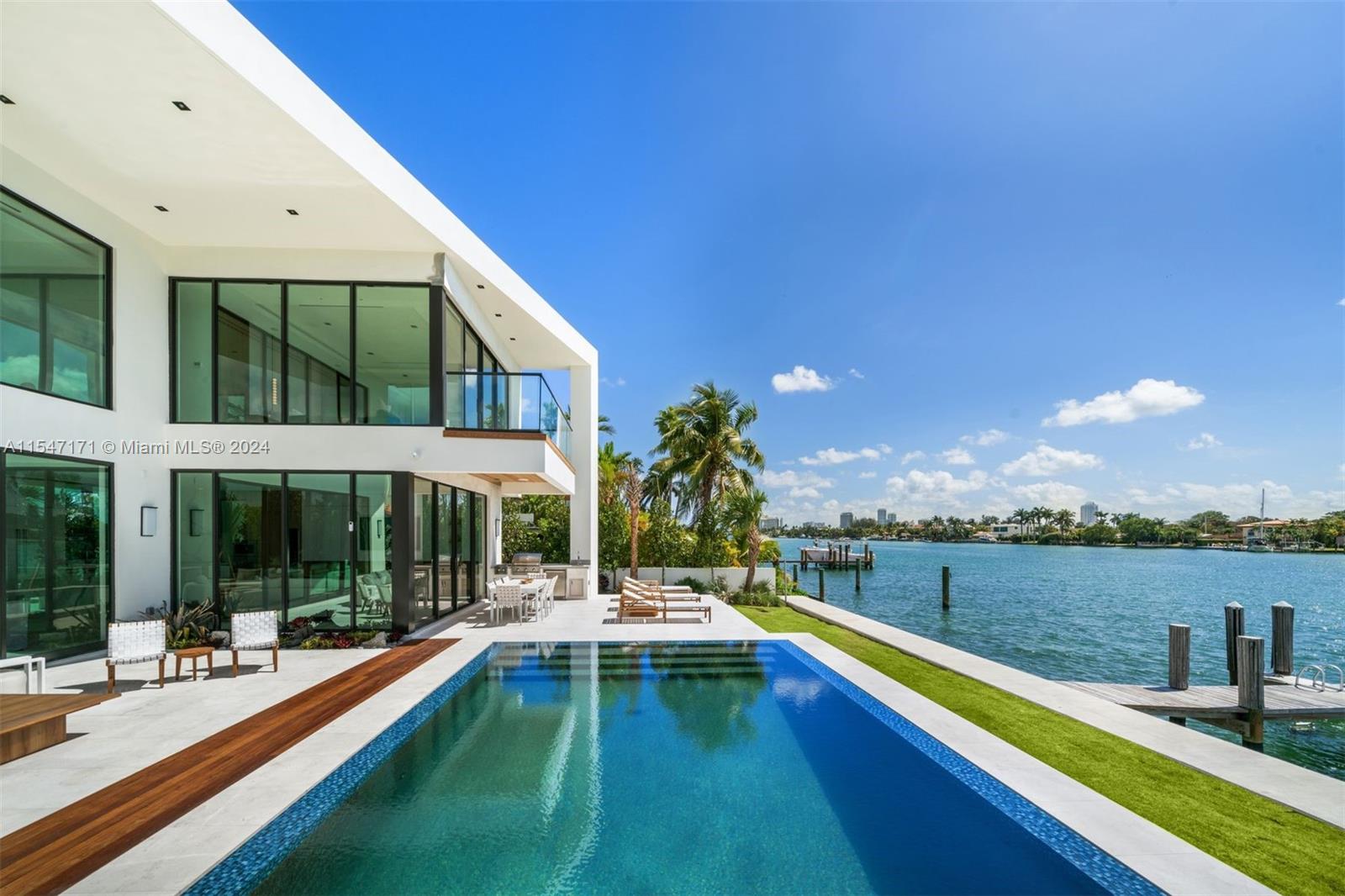 Indulge in opulent waterfront living in this brand-new construction home with a premier lot position on the wide bay in gated Biscayne Point. Enjoy the most sought-after Southern Exposure close to the tip of the island. Designed by Tamara Feldman, this modern masterpiece boasts 7BD/7+1 BA. The exquisite interior features Tundra grey Marble & White oak flooring, white oak wrapped floating staircase, & Carrara marble in all guest bathrooms. The exterior facade is wrapped in stone, complemented by a knife-edge pool & stunning water views. Enjoy a chef’s kitchen w/ marble & custom white oak, top of the line appliances, a media room, staff quarters & full cabana bath. Revel in luxury & sophistication at every turn in this stunning waterfront retreat.