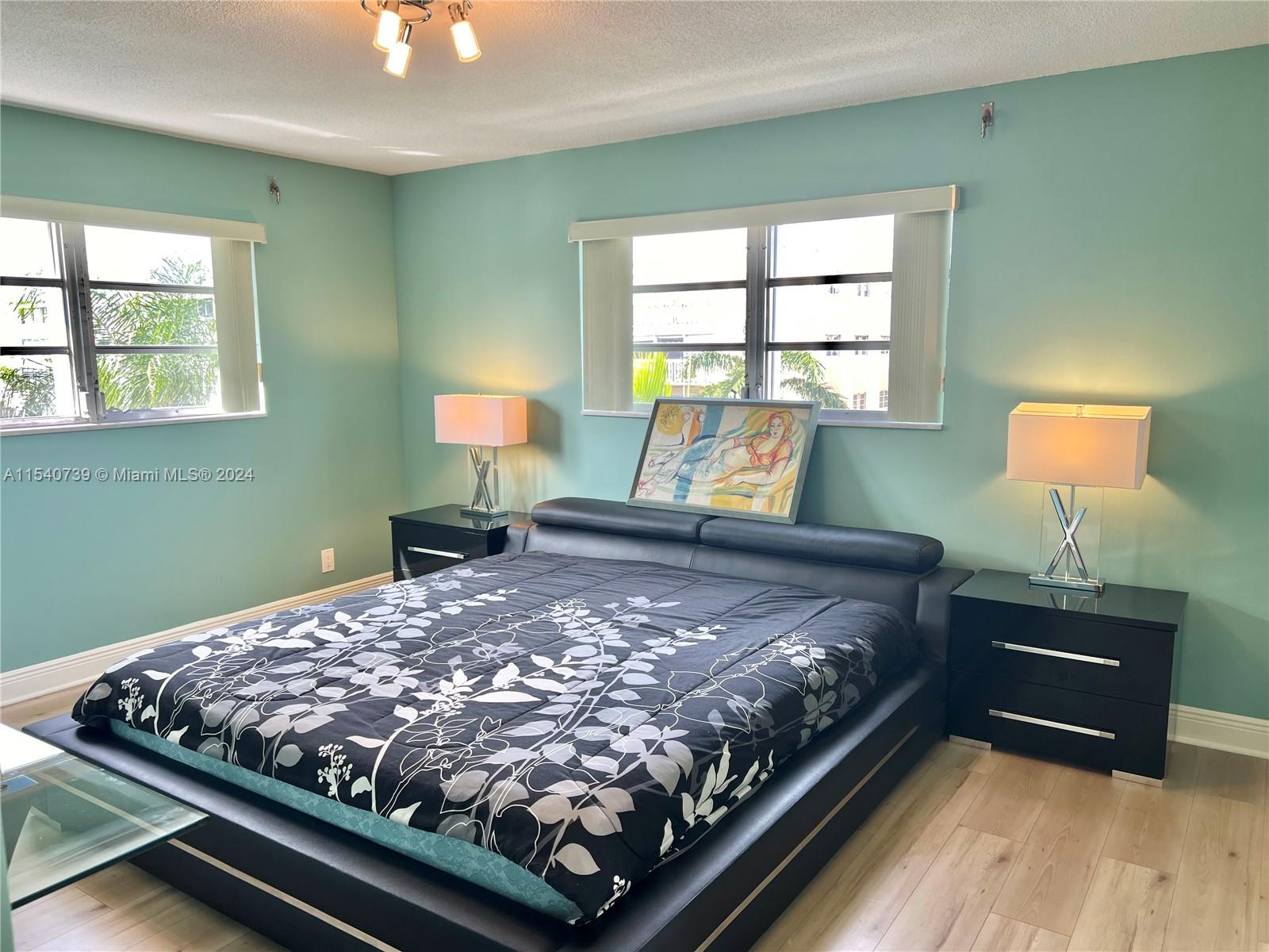 Large oversized primary bedroom with 3 custom built-in walk-in closets, updated ensuite and double window exposure. 
Windows overlook the beautiful coutryard. 
Hurrican shutters.