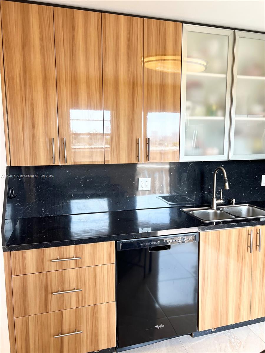 Beautiful frosted upper cabinet. 
Double basin sink.
Modern cabinet pull handles.