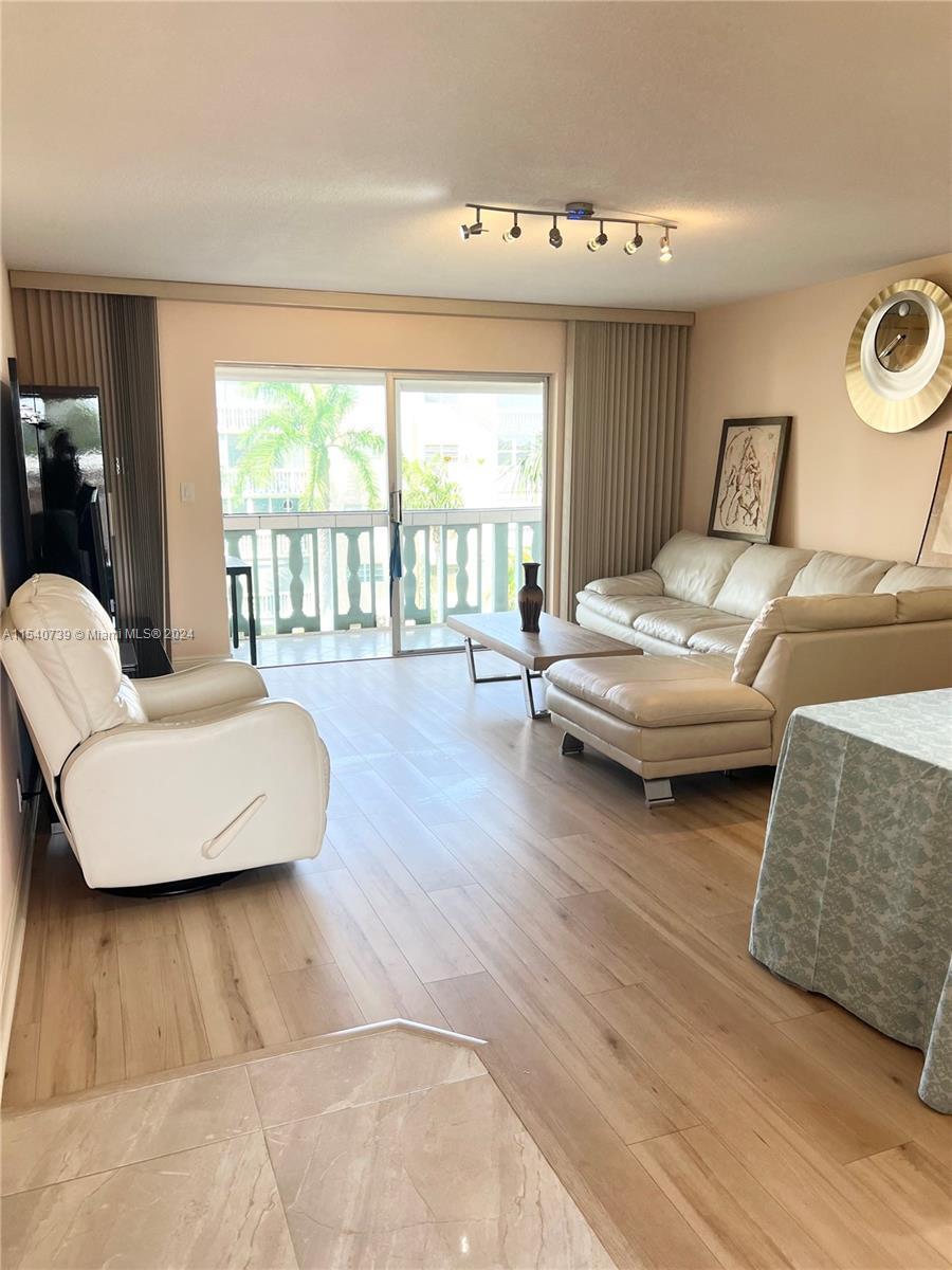 Large living and dining room receives a great deal of natural sunlight.
Very spacious screened in balcony & hurricane shutters. 
Beautiful view overlooks the expansive green courtyard and mature palm trees.