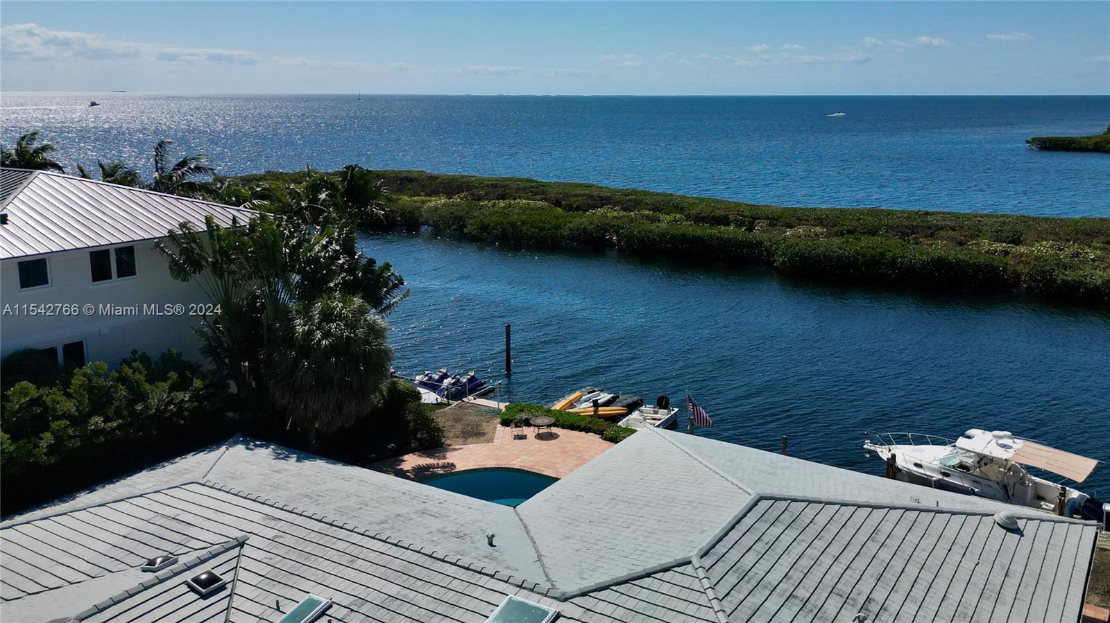 Boater's Paradise! A 12,000 square ft lot with 100 linear ft seawall. Prime location with views of Biscayne Bay which are wide open to the East and visible over a protective hedge of mangroves to the South. From your back door, be out on the bay in seconds. The great room, kitchen, and bedrooms face the water and are bathed in sunlight through panoramic windows which provide amazing views.  This property is move-in ready for the next owner to enjoy the best of Miami waterfront living, but also affords a tremendous opportunity: if redeveloped to the elevation of neighboring homes, this lot will offer endless wide open bay front views.  Either way an incredible investment!