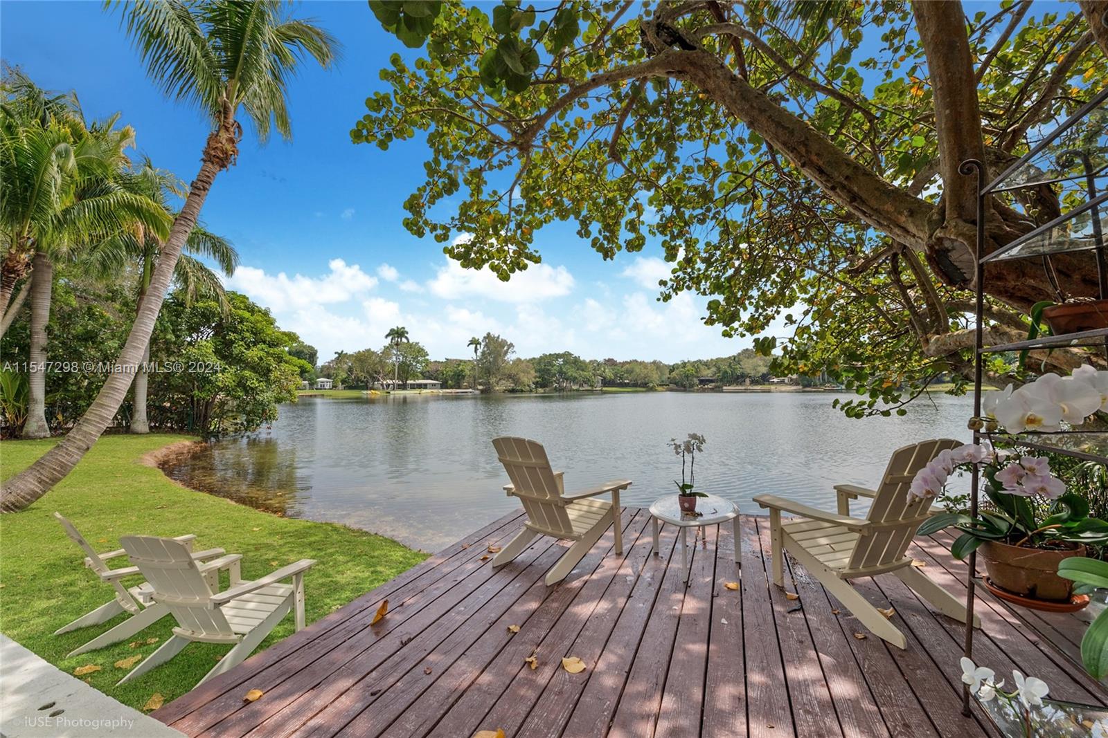 Privacy gates open to a deep lake-front acre and private oasis in South Gables, minutes from top schools and the South Miami town center. A long drive, framed by an expansive front lawn, leads to the one story home set far back from the street. Bright, open spaces and a sleek kitchen evoke casual lake-front enjoyment, with the focal point being the large yard sloping to the Lake and deck. Great potential to expand or rebuild on a special piece of rarely available lake-front land. Make this your own private retreat, seemingly away from it all and yet so close.