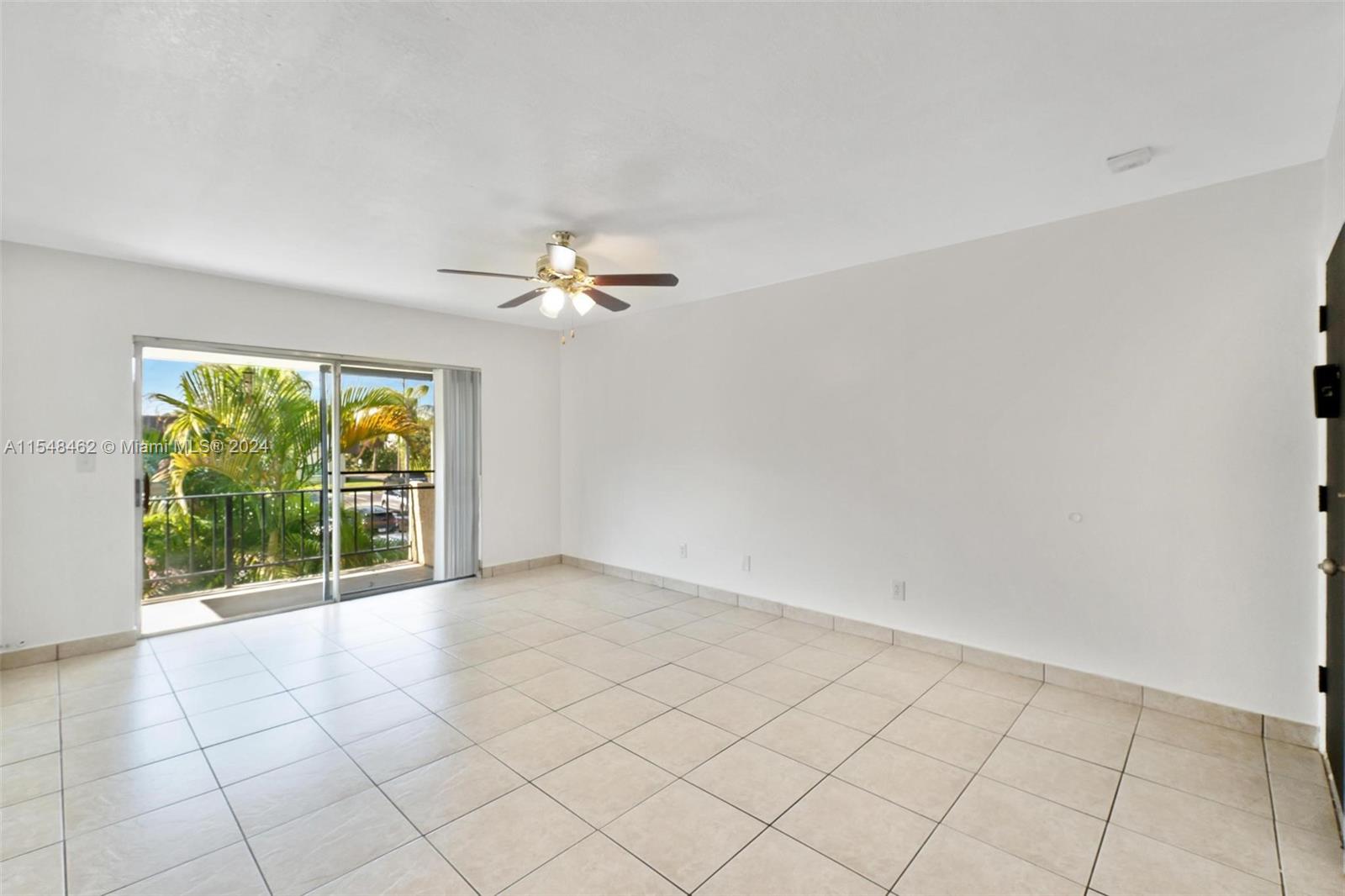 Large living area with sliding glass window to balcony