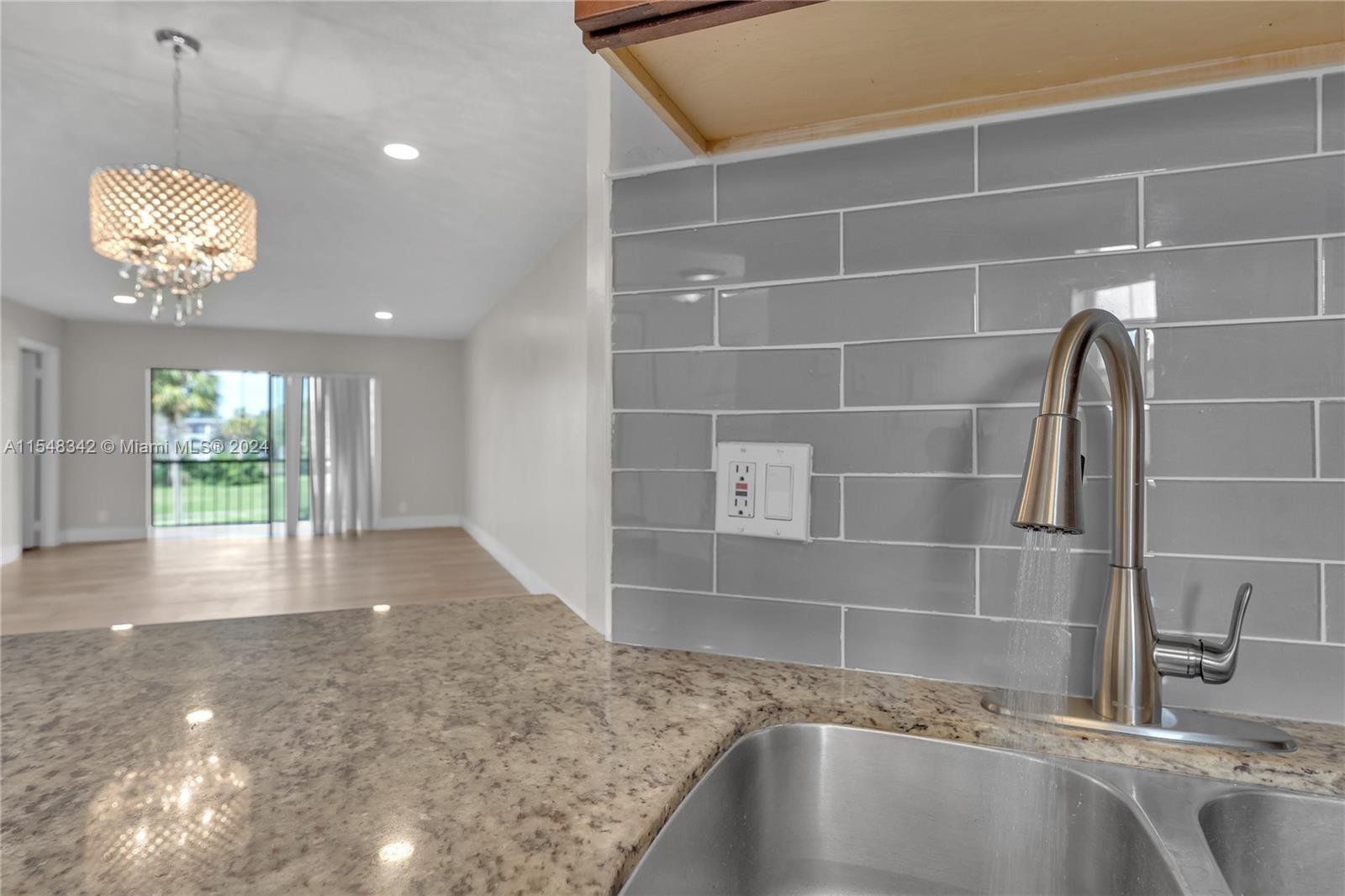 Partial View of Kitchen w/Glimpse of Dining and Living Room