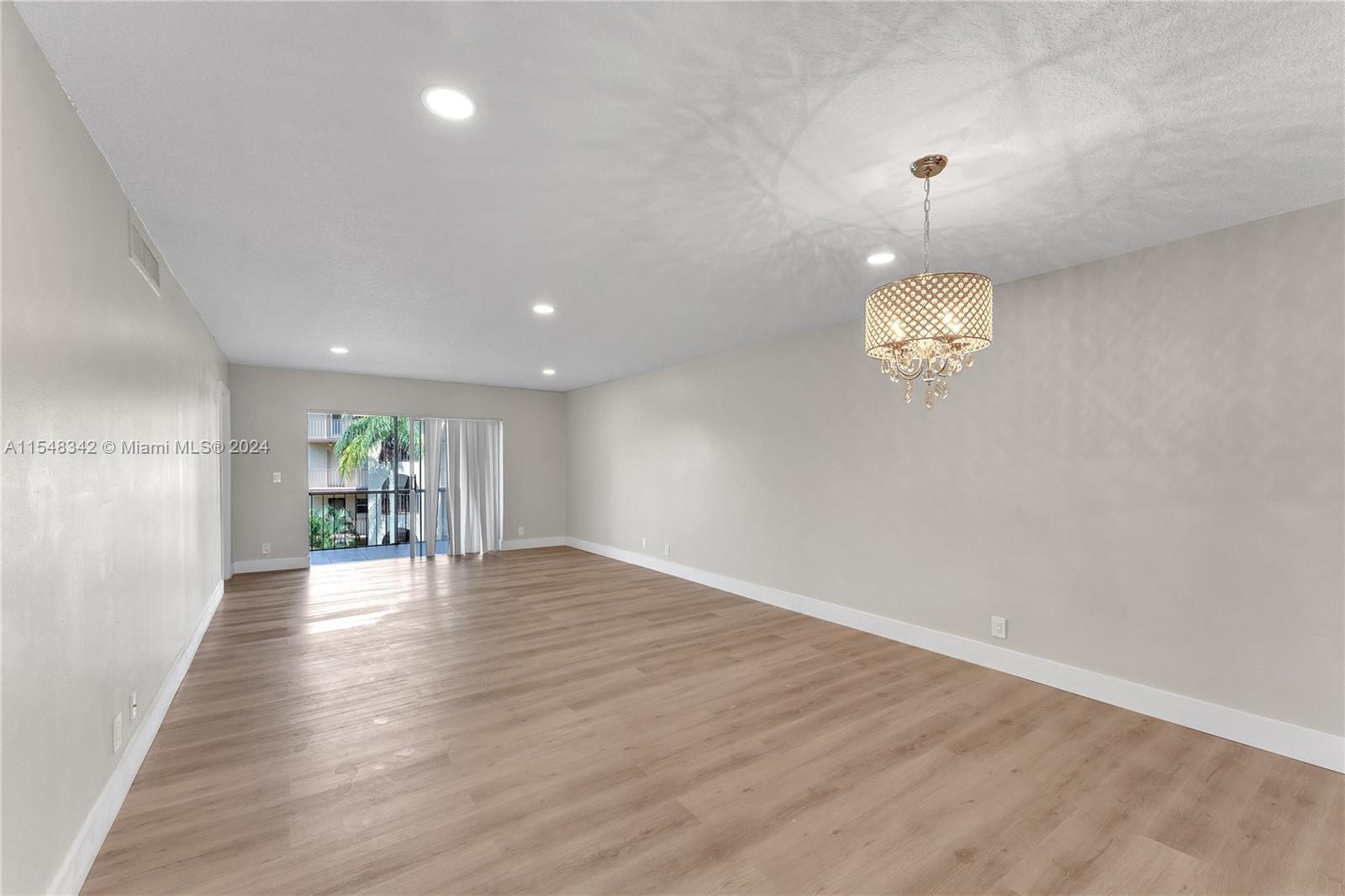 Living Room/Dining Room w/ Glimpse of Patio and outside