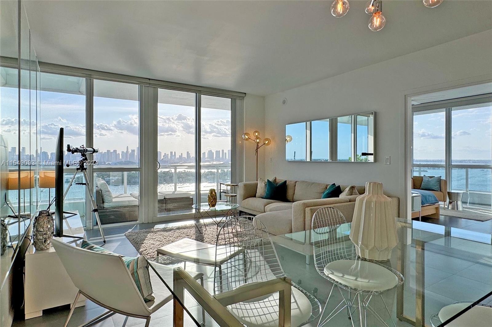 Sitting on the 21st floor in the heart of South Beach and directly on the water, this 2 bed/2 bath condo spans 3 sides of the building with floor-to-ceiling windows and a wrap-around balcony providing breathtaking nearly 360 degree views of Biscayne Bay and the Miami skyline, South Beach and the Atlantic. Fully furnished to high standard, its master bedroom has 2 walk-in closets and a spacious imported marble bathroom, while the 2nd bedroom and bathroom are located on the opposite side of the building creating a private area for guests/children. Kitchen includes stainless appliances & marble countertops. The exclusive Bentley Bay includes a state-of-the-art gym, sauna, hammam, cold plunge, pool deck with 2 spas, & valet parking. 30-day rentals permitted. Available April 1st, 2024