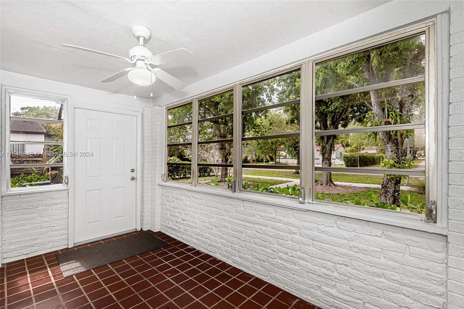 view toward entry door and showing the many windows